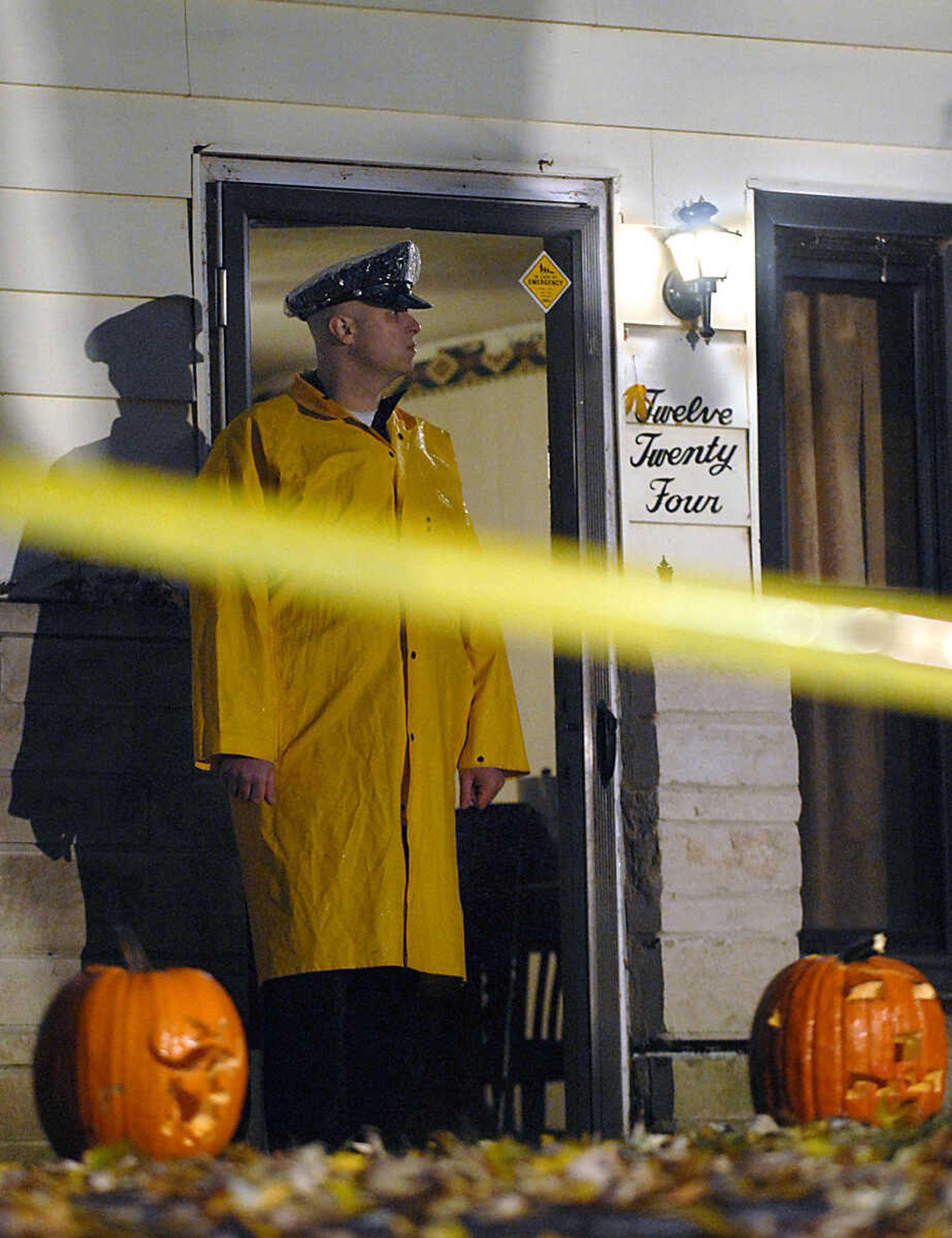 KIT DOYLE ~ kdoyle@semissourian.com
Cape Girardeau policeman Aaron Brown stands in front of 1224 N. Missouri St., the scene of a double homicide near Capaha Park early Tuesday morning.