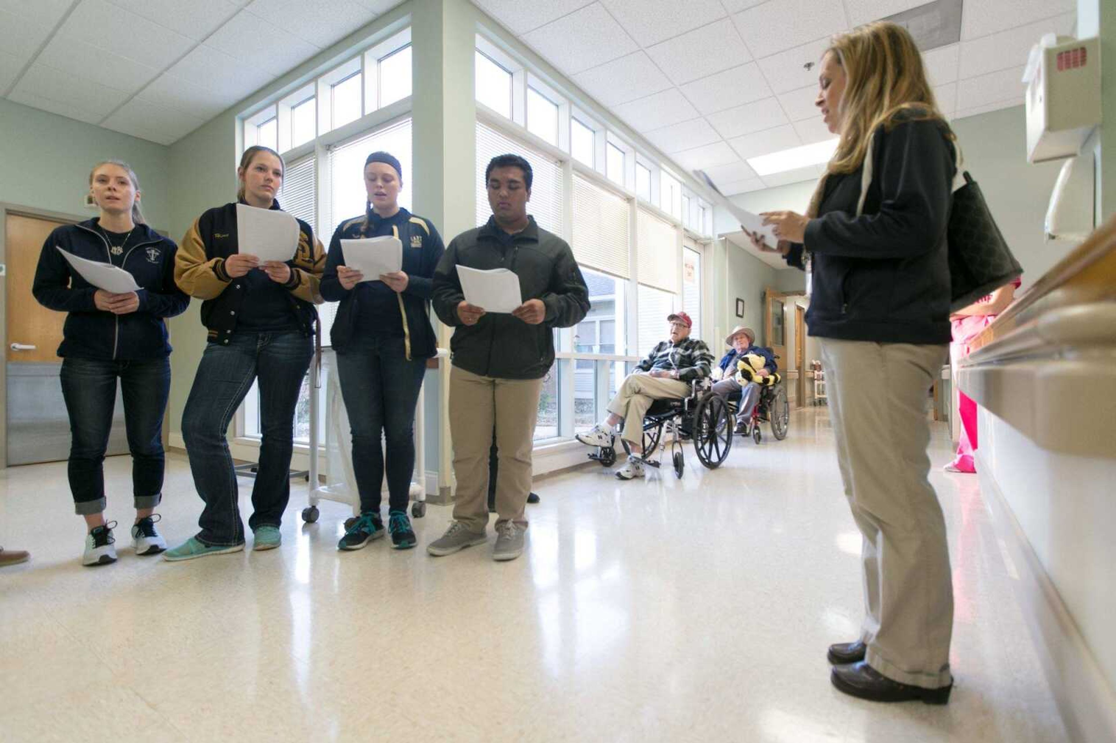 The Saxony Lutheran High School Beta Club moves through the halls of the Missouri Veterans Home as they sing Christmas carols Dec. 8 in Cape Girardeau. (Glenn Landberg)