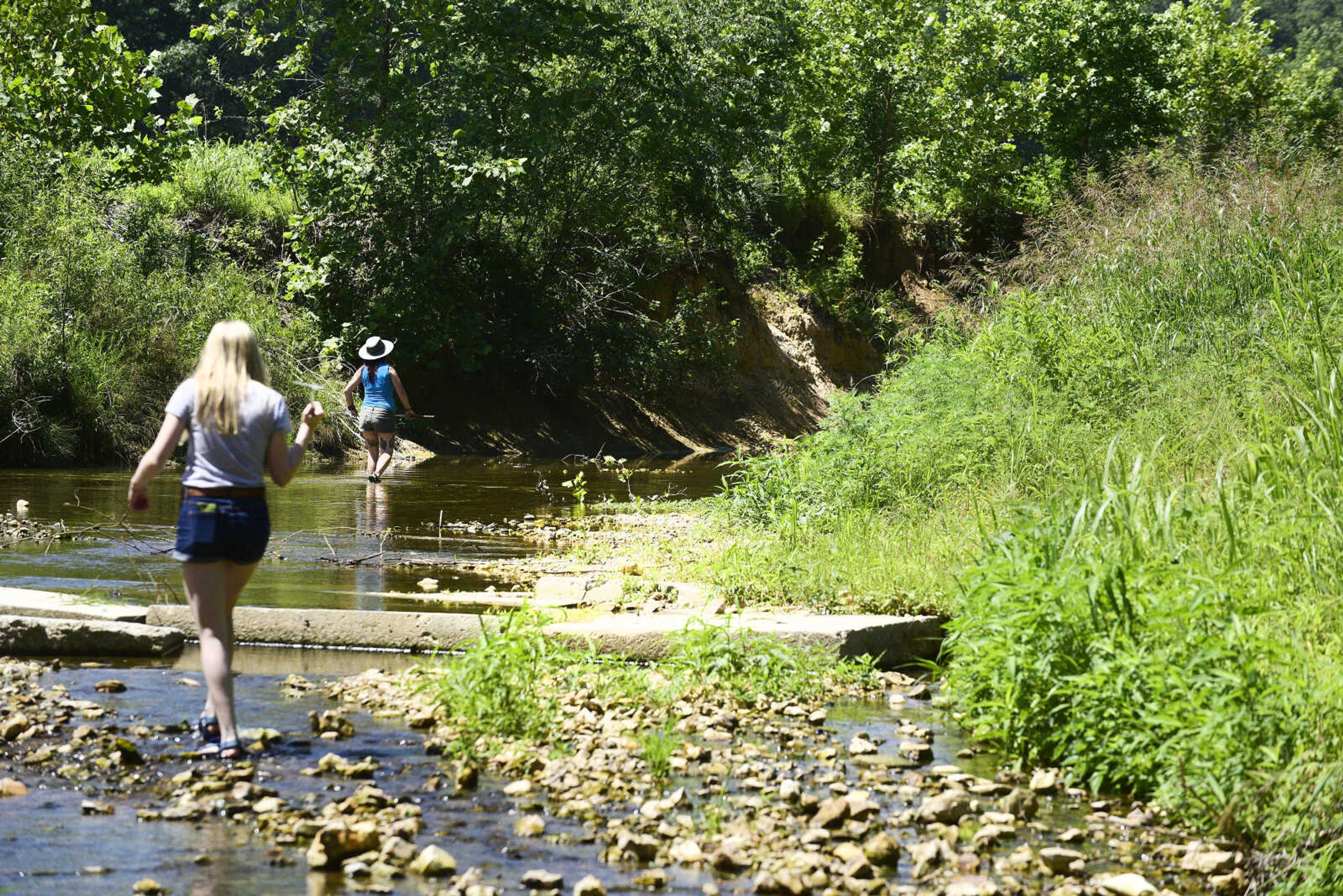 Jordyn Richmond, left, and Anna Mae Zembsch go herping in Little Indian Creek near Oriole, Missouri.