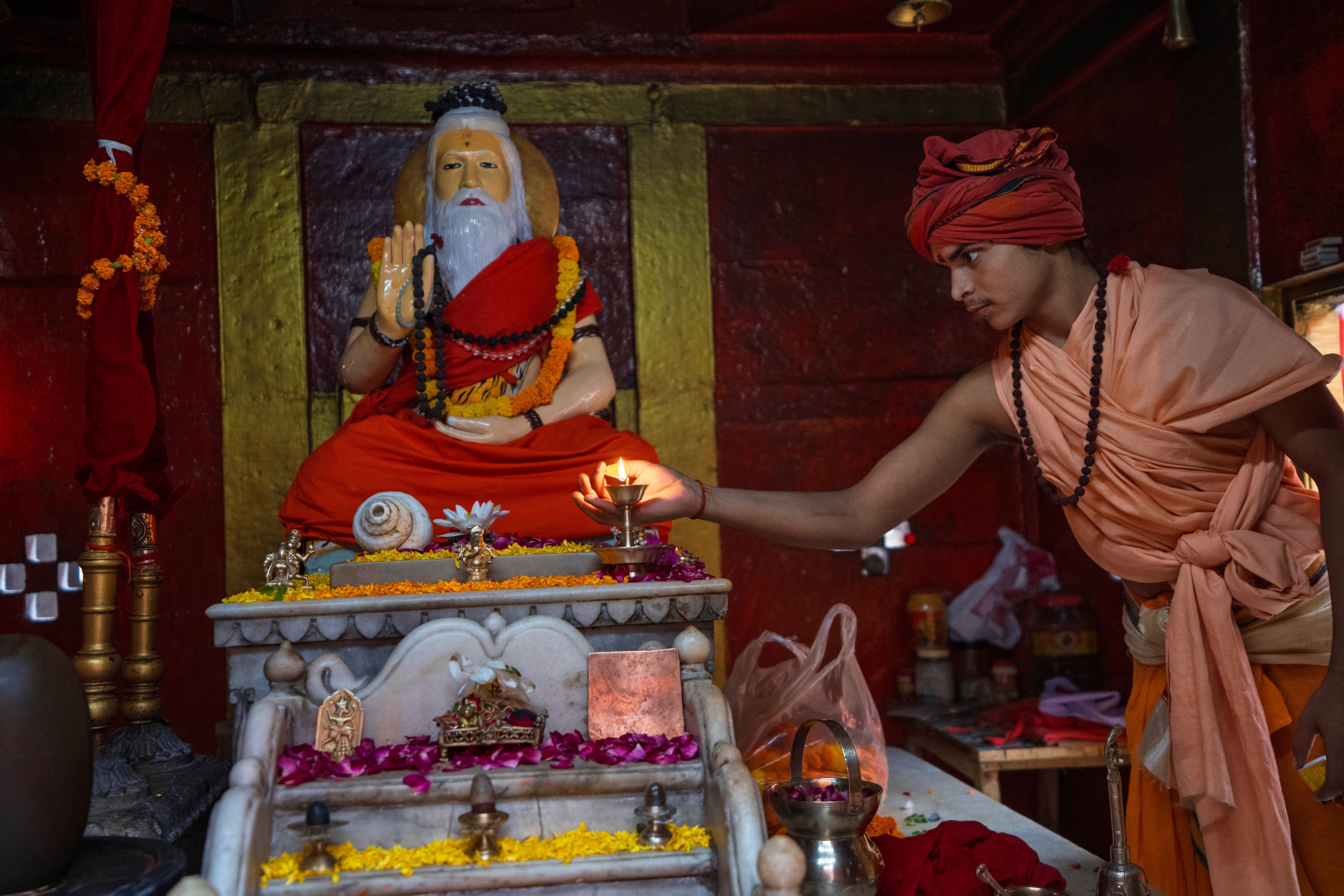 A young Hindu holy man performs an evening ritual in front of their Guru Bhagwan Sri Guru Kapil Mahamuni in Shri Panchayati Akhada Mahanirvani at Prayagraj in the northern Indian state of Uttar Pradesh, India, Thursday, Oct. 17, 2024. (AP Photo/Rajesh Kumar Singh)