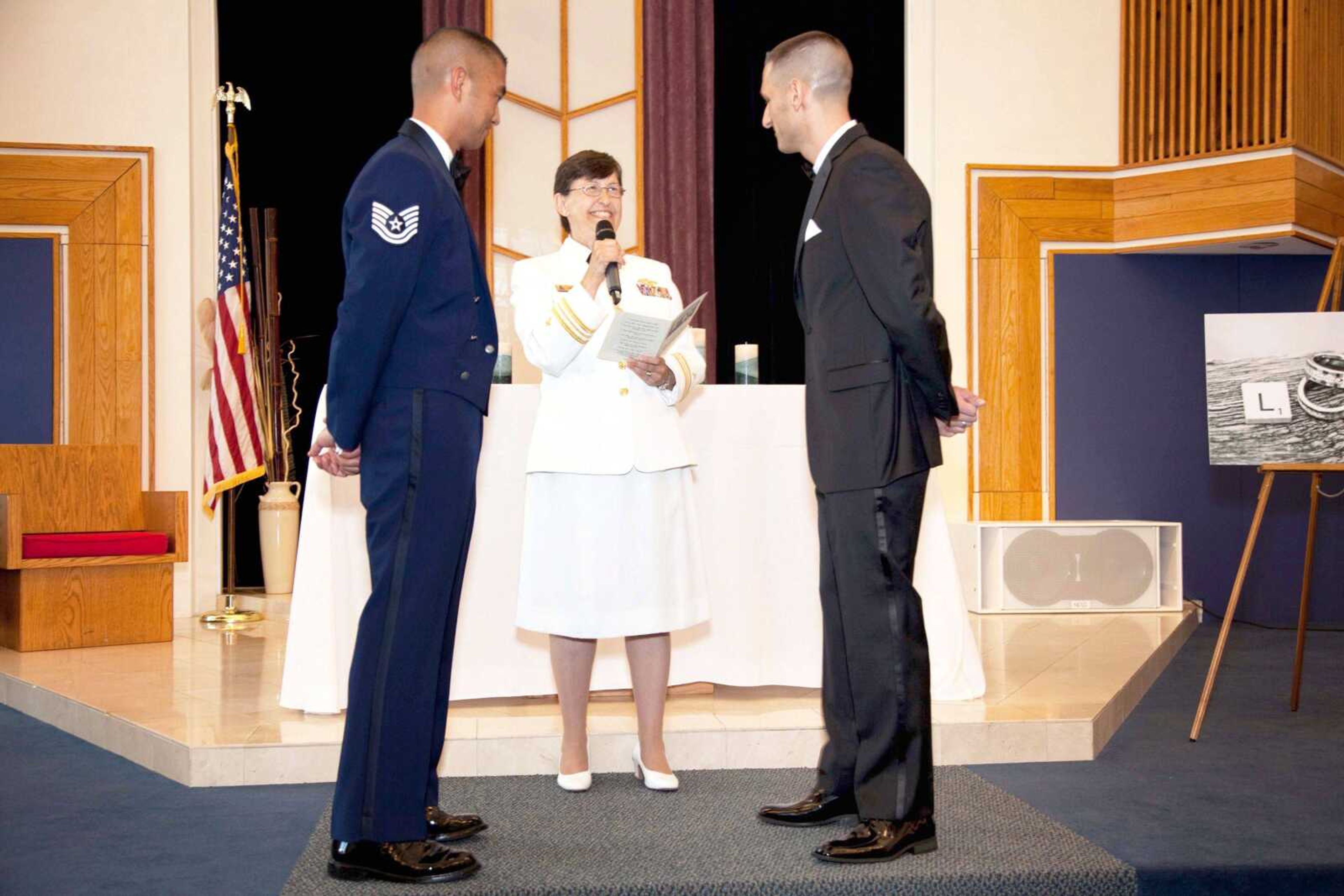 Navy Chaplain Kay Reeb of the Evangelical Lutheran Church of America officiates the civil union ceremony of Air Force Tech. Sgt. Erwynn Umali, left, and his partner, Will Behrens, on June 23 at Joint Base McGuire-Dix-Lakehurst, the military base in Wrightstown, N.J., where Umali is stationed. (Jeff Sheng)