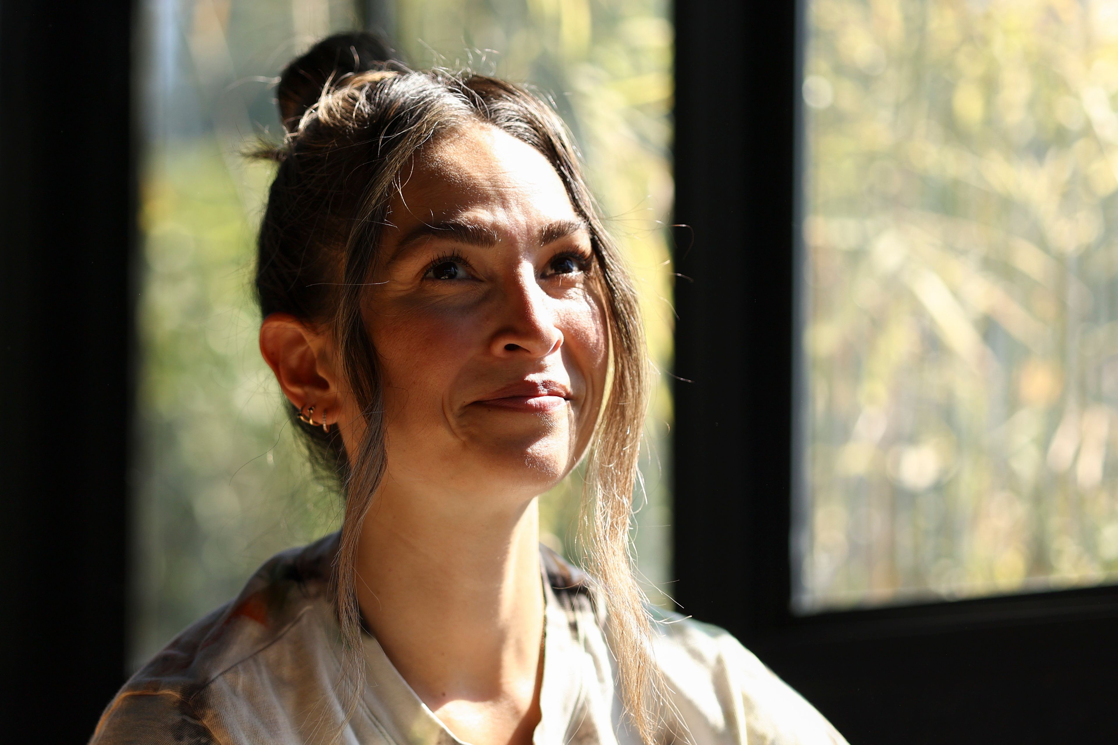 Headspace meditation teacher, Rosie Acosta, looks on in her sun room Monday, Sept. 30, 2024, in Woodland Hills, Calif. (AP Photo/Jessie Alcheh)