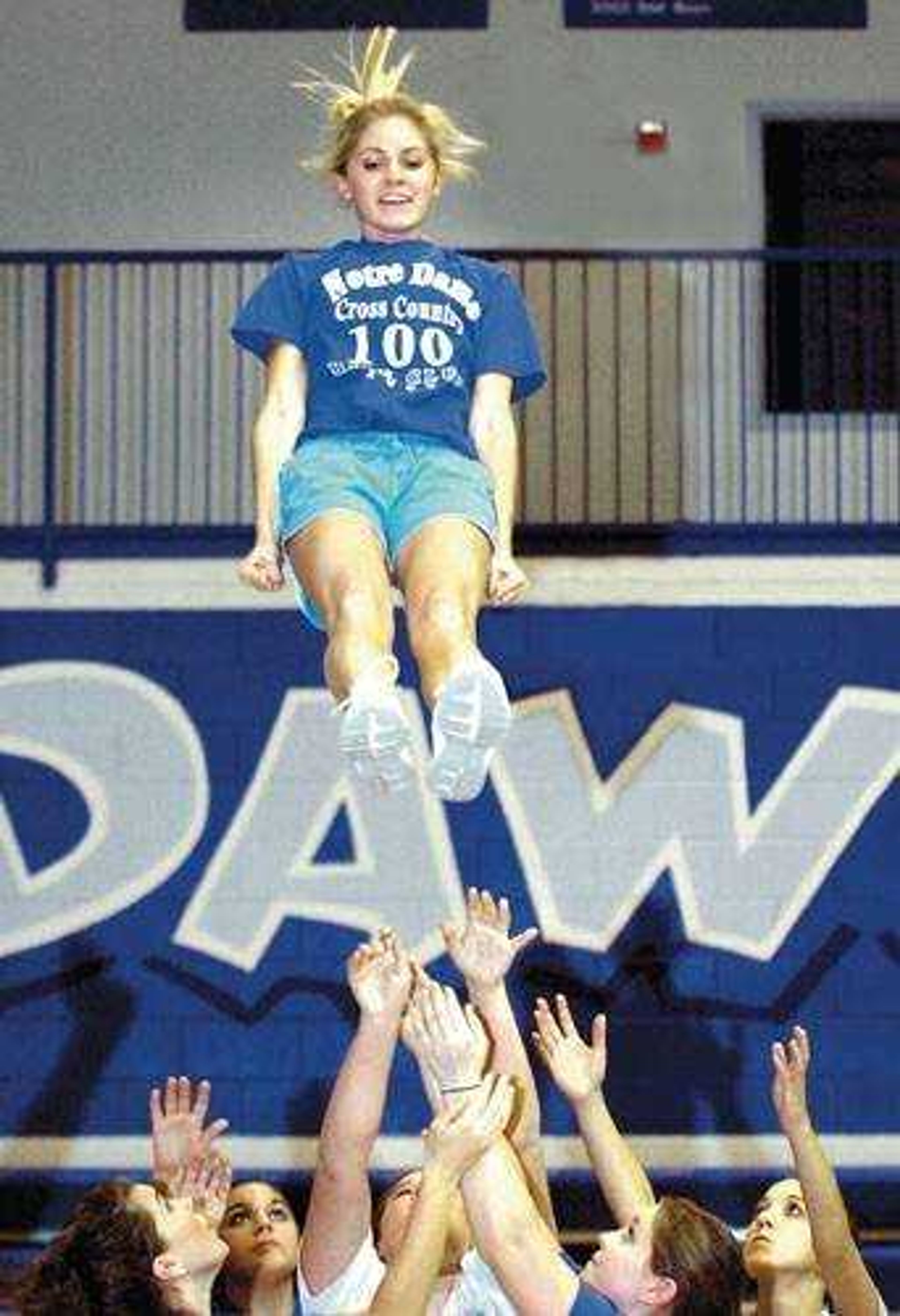 Notre Dame varsity cheerleader Brooke Heischmidt prepared to be caught as she and her teammates practiced a basket toss in the high school gym recently. (Don Frazier)