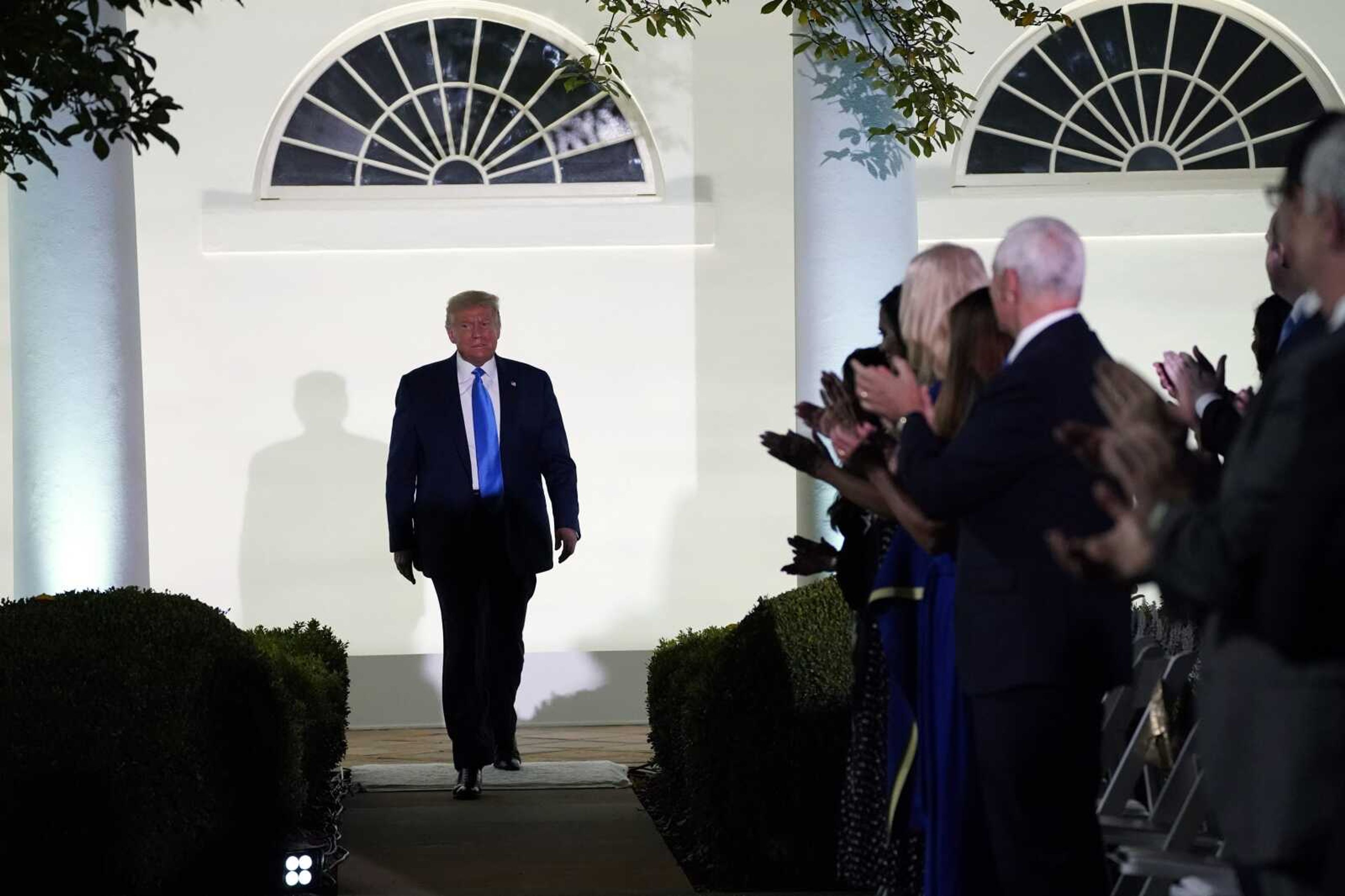 President Donald Trump arrives to listen to first lady Melania Trump speak during the 2020 Republican National Convention on Tuesday from the Rose Garden of the White House in Washington.