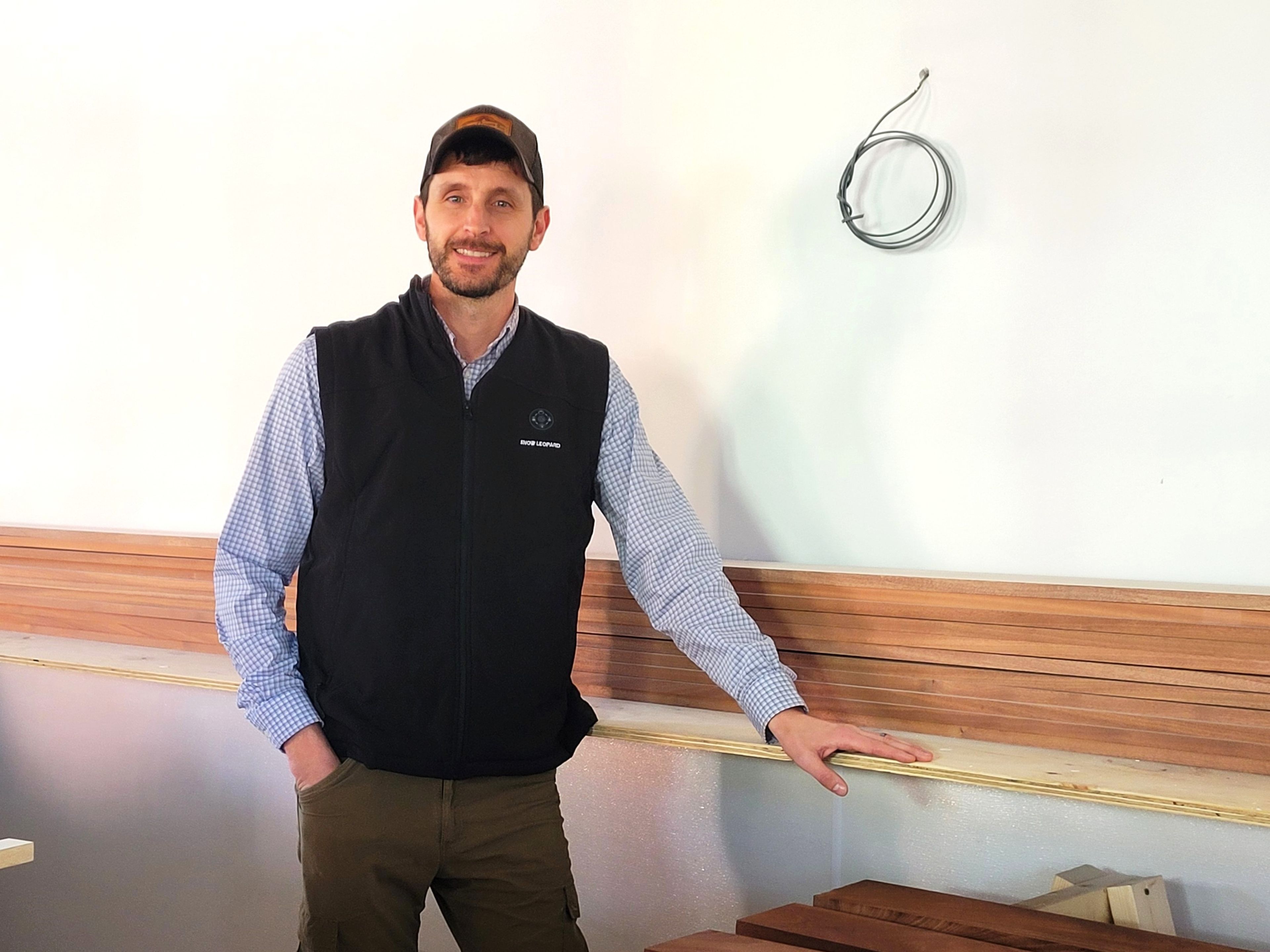 Drew Clare, general manager of The Benn Conger Inn, will also be the GM for the apartments that will soon be available on the second and third floors of The Groton Hotel. Pictured here, Clare is admiring the mahogany planks that recently arrived, which will be used for the bar and decorative trim on the first floor of the hotel, soon to be fully restored, renovated and ready for the community to dine in once again.