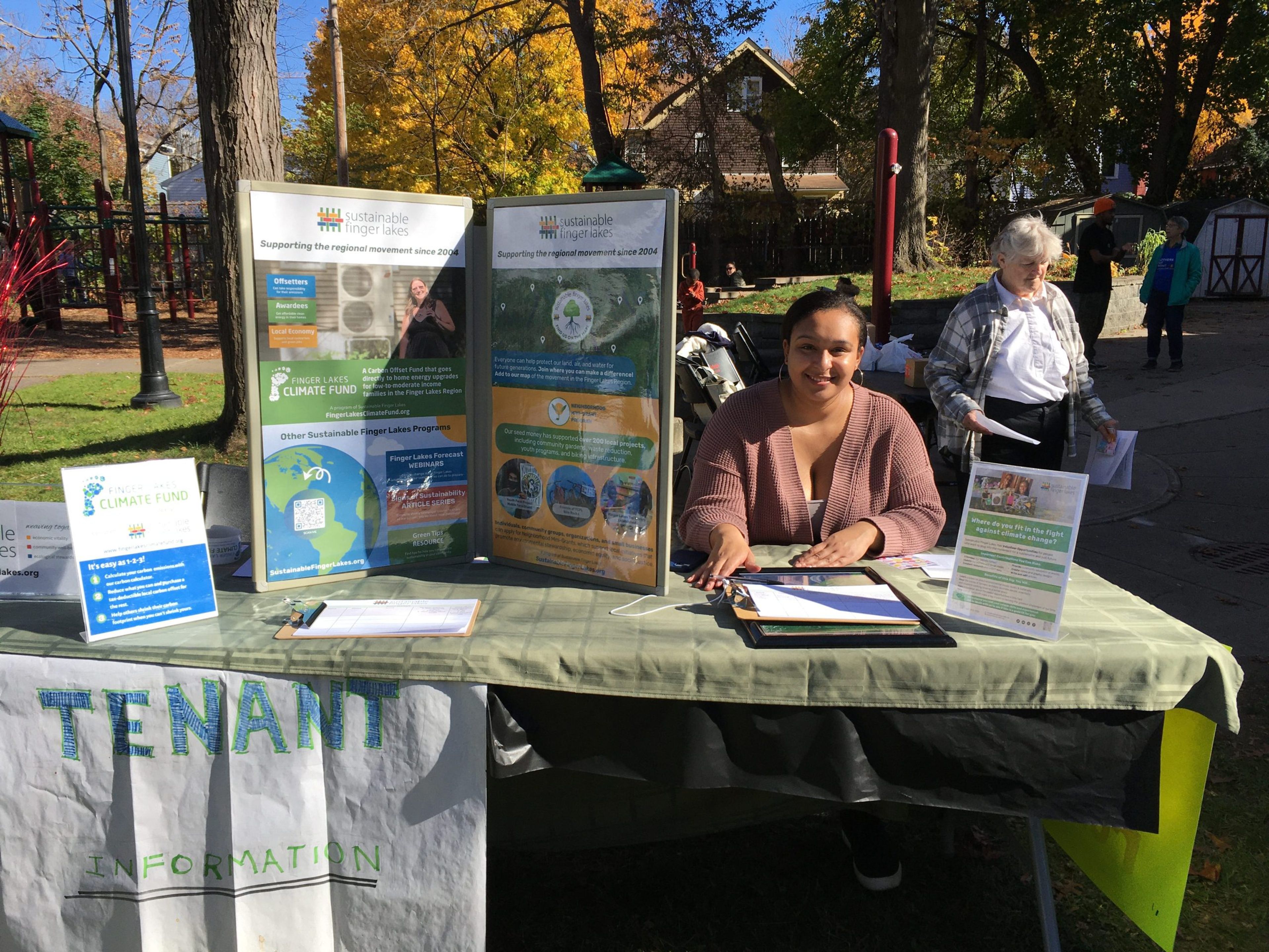 Milena Bimpong, the tenant engagement coordinator at Sustainable Finger Lakes, ran the SFLX information table at a Southside Community Center event last fall. Provided by Sustainable Finger Lakes. Photo Provided