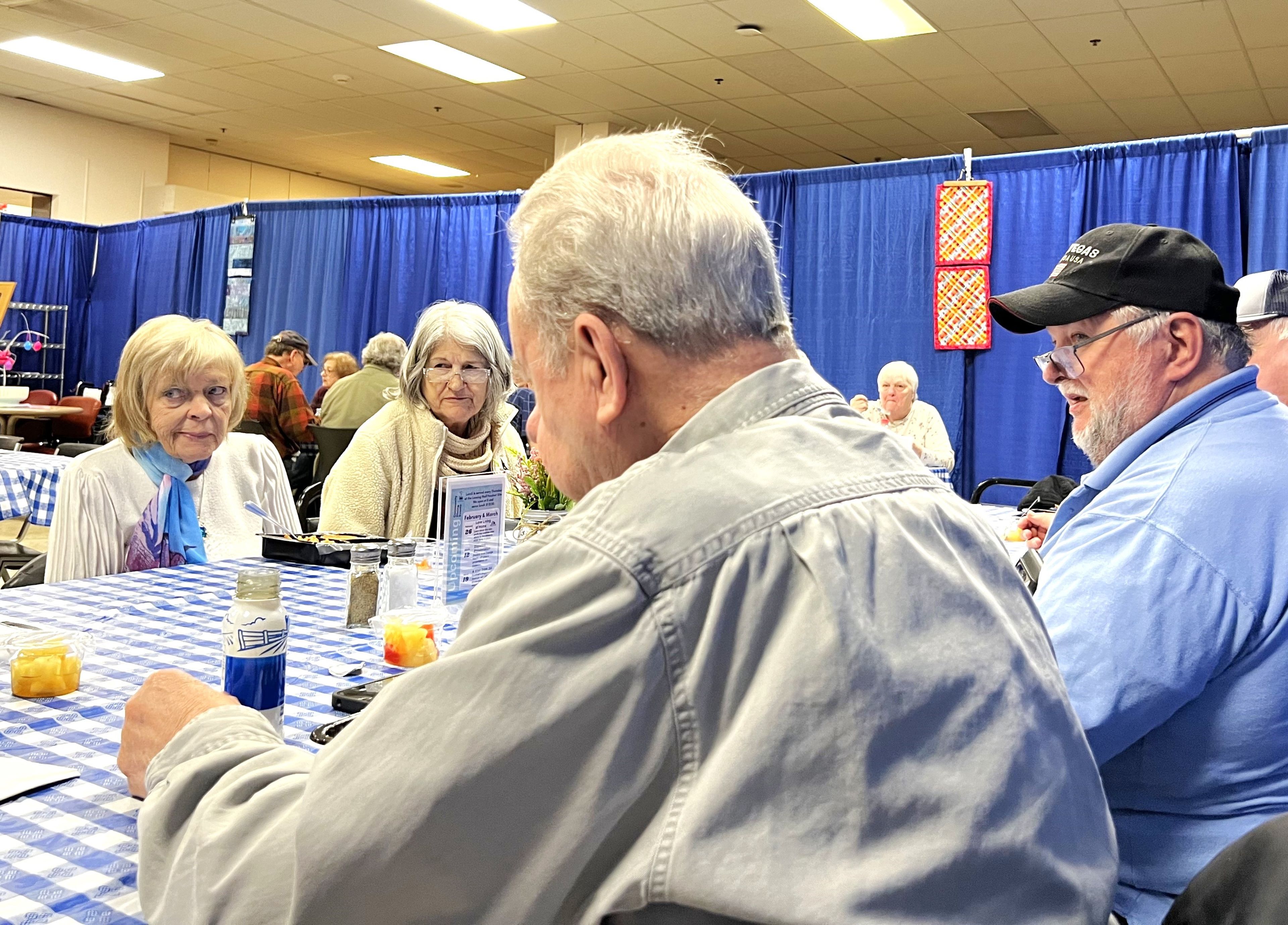 The Foodnet Meals on Wheels location at the Shops at Ithaca Mall has become a popular spot for local older adults, who enjoy a free hot meal while catching up with each other once a week. From left to right: Marta Weiner, Titiz Perkins, Buzz Nelson and Doug Volbrecht. 
