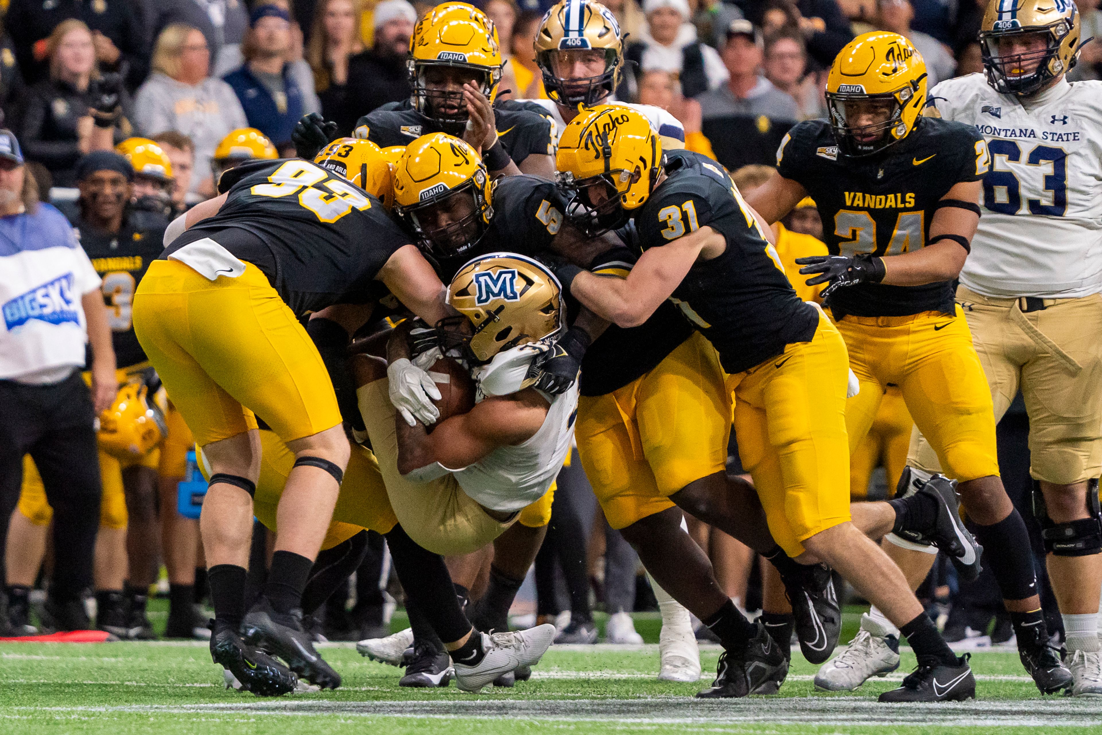 Idaho defenders work together to tackle Montana State running back Julius Davis (32) during a game on Oct. 28, 2023 at the P1FCU Kibbie Dome in Moscow.