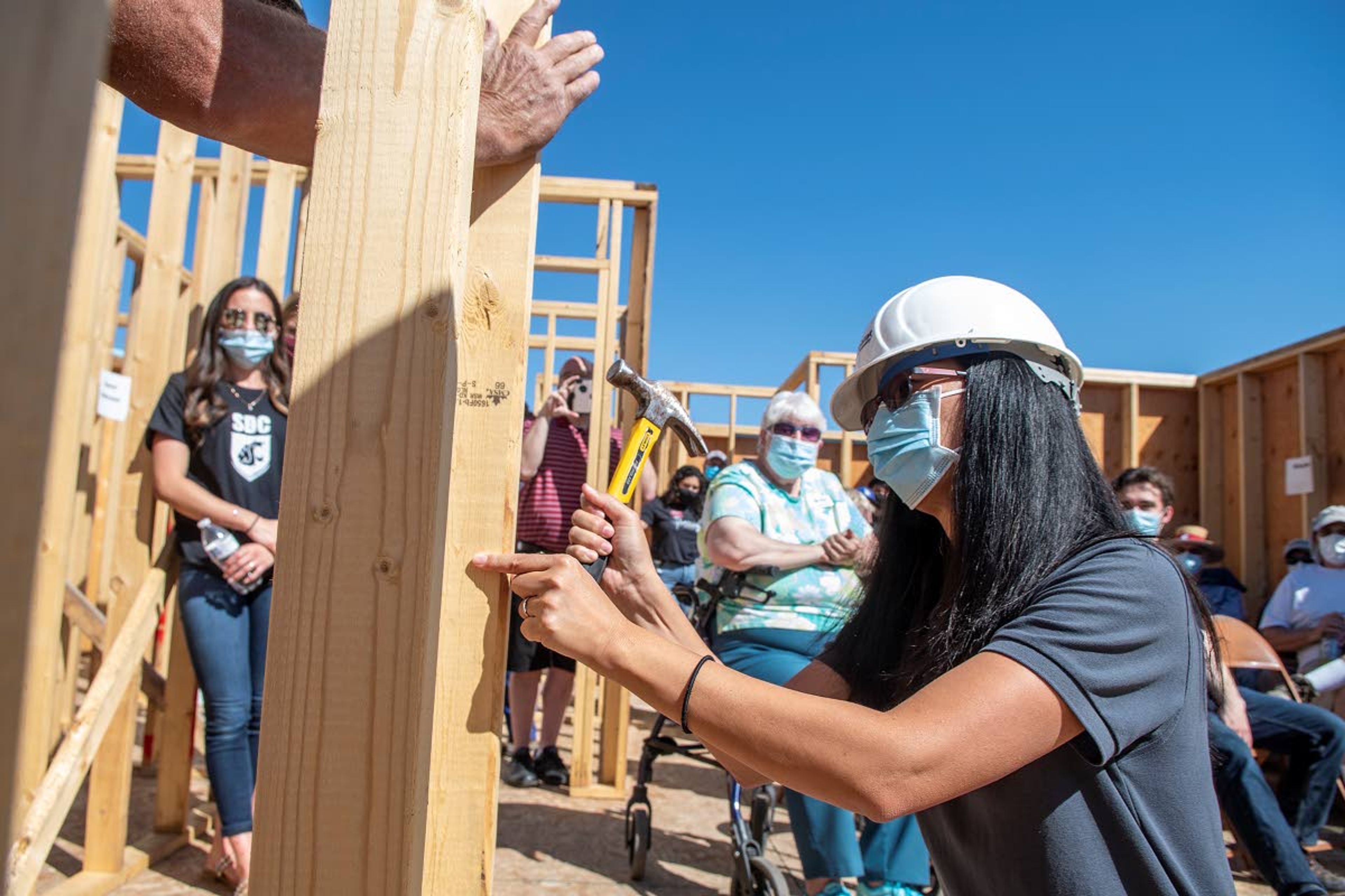 Palouse Habitat for Humanity board chair Cathy Blood hammers one last nail into the final wall of an energy efficient house in Uniontown on Thursday afternoon.