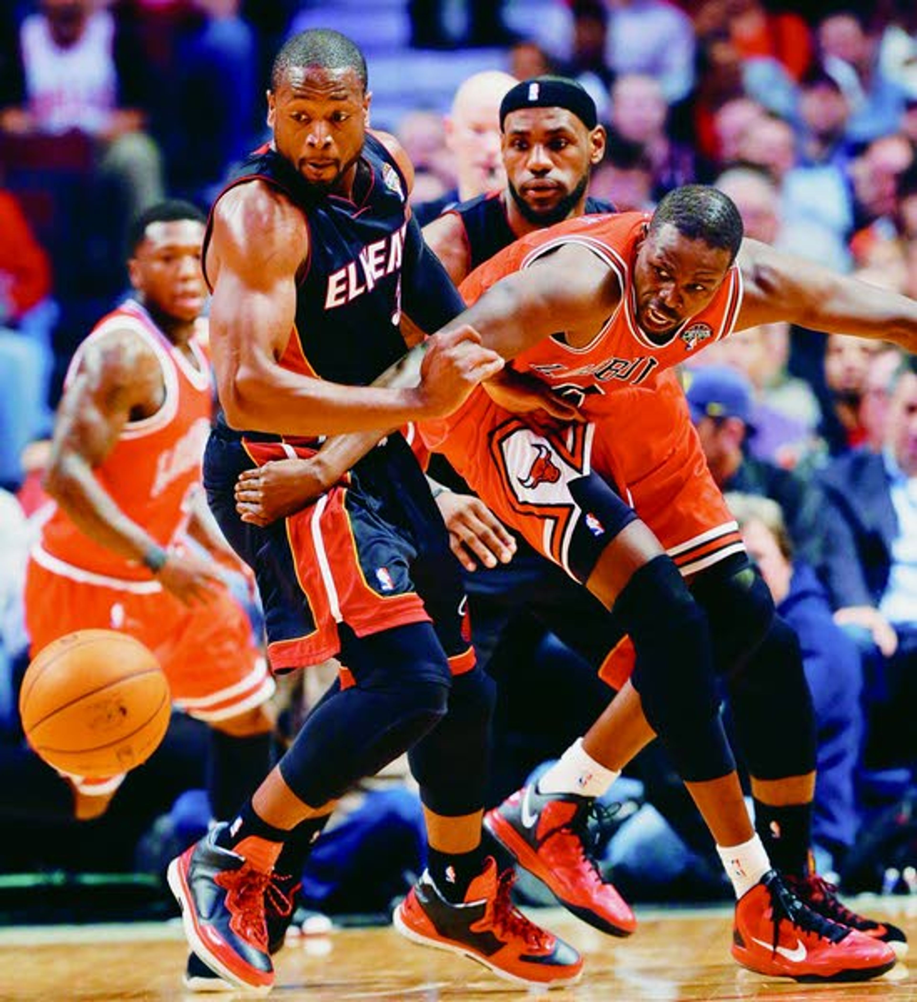 Miami Heat guard Dwyane Wade, left, forward LeBron James, center, and Chicago Bulls forward Luol Deng watch a loose ball during the first half of Wednesday’s game in Chicago. The Bulls won 101-97, snapping the Heat’s 27-game winning streak.