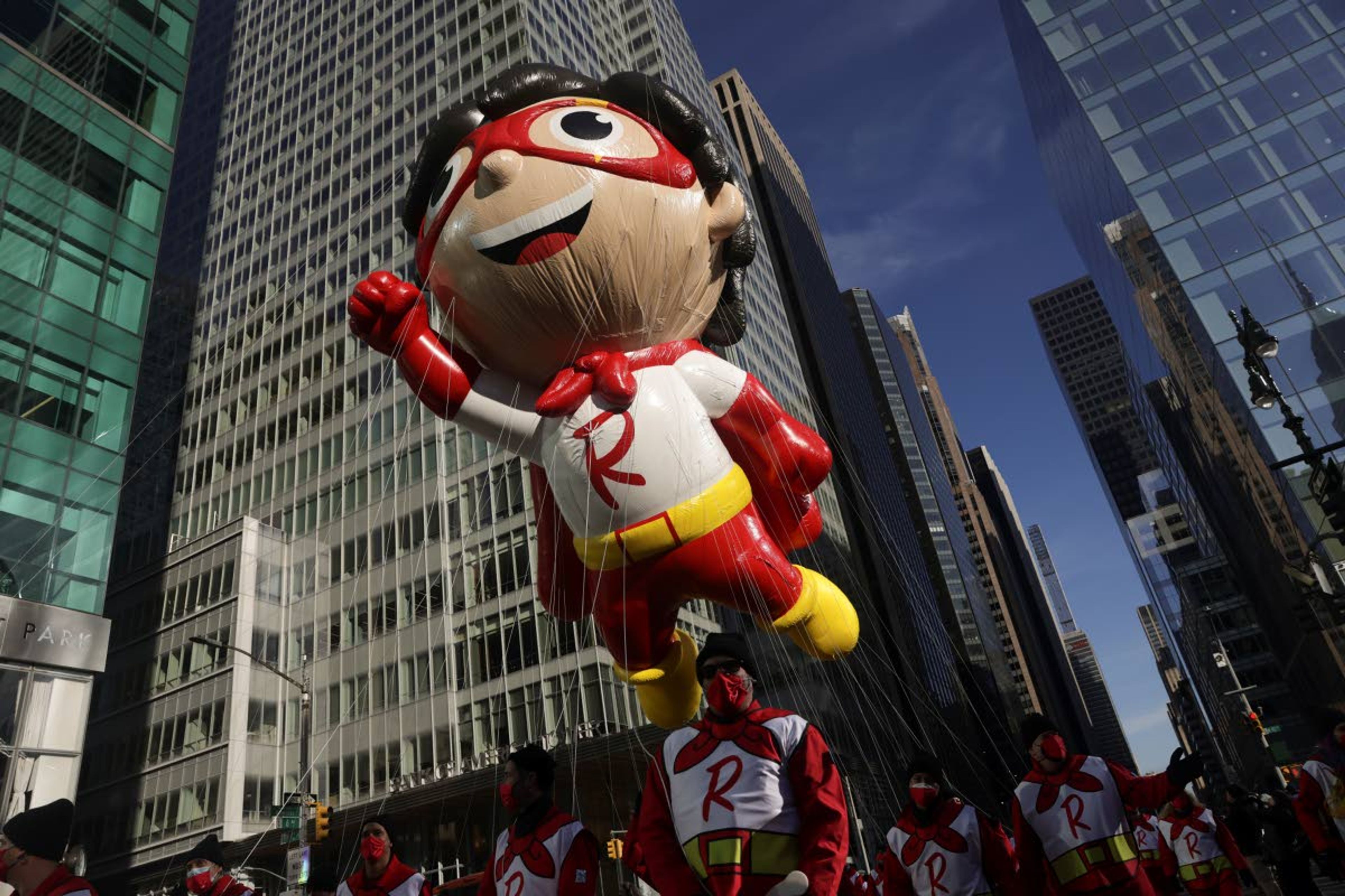 The Red Titan ballon makes its way down Sixth Avenue during the Macy's Thanksgiving Day Parade, Thursday, Nov. 25, 2021, in New York. The Macy's Thanksgiving Day Parade is returning in full, after being crimped by the coronavirus pandemic last year. The Thanksgiving parade is the latest U.S. holiday event to make a comeback amid the ongoing pandemic. (AP Photo/Jeenah Moon)