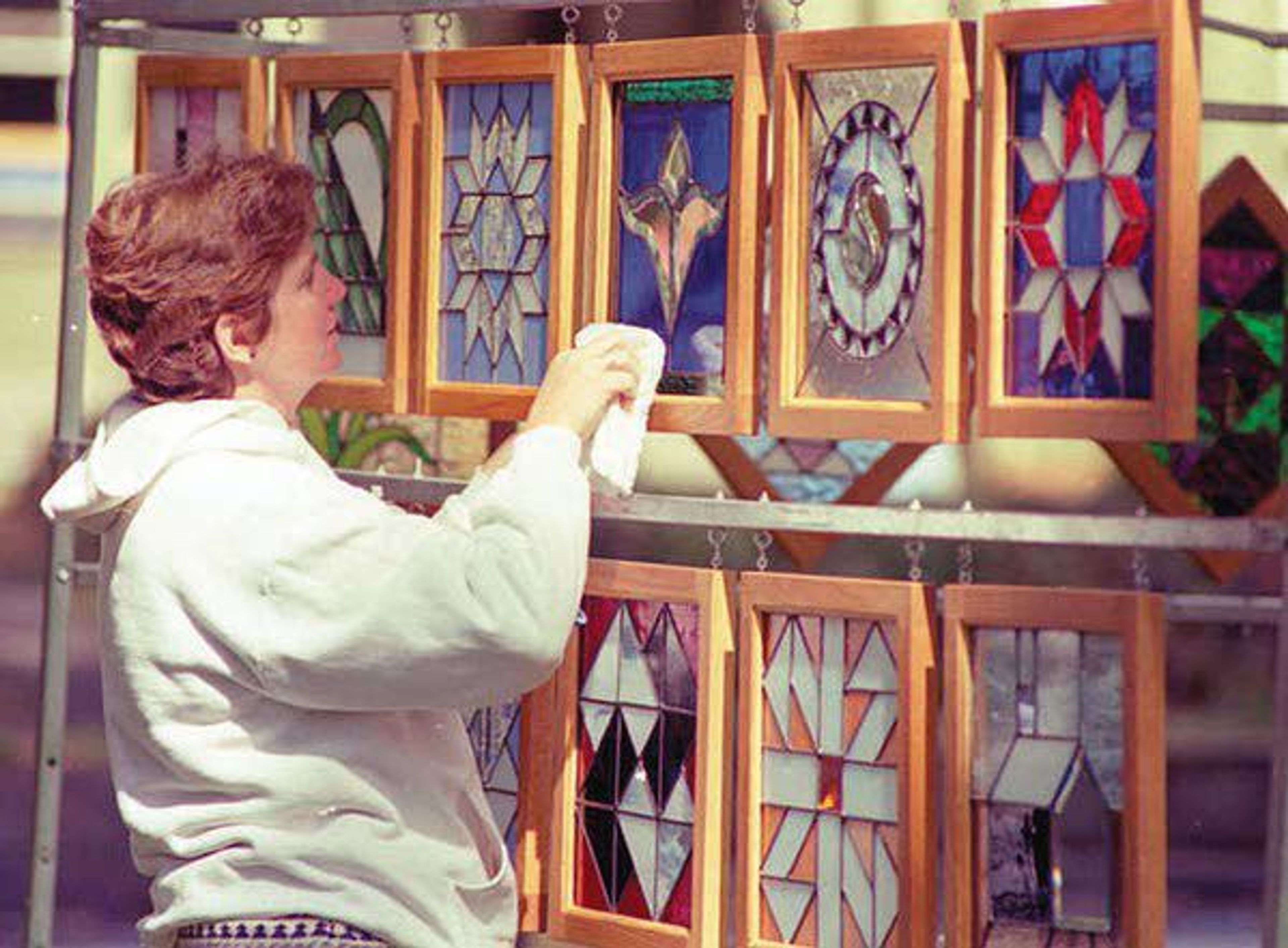 A artist cleans her stained-glass pieces at the National Lentil Festival in 1993.