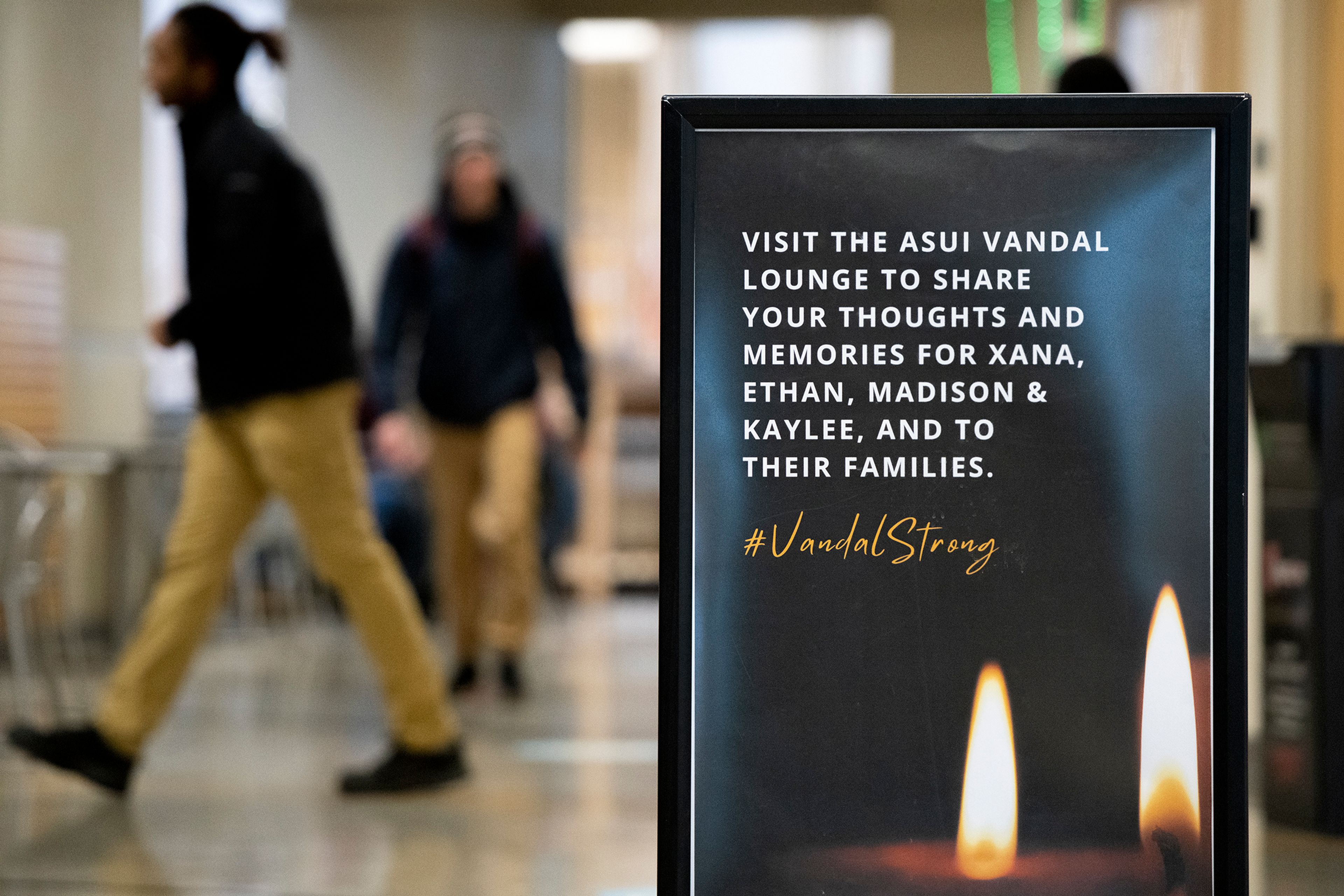 A sign encouraging passersby to share thoughts and memories for the four student victims of an off-campus homicide sits in the Idaho Student Union Building as University of Idaho classes resume on the Moscow campus.