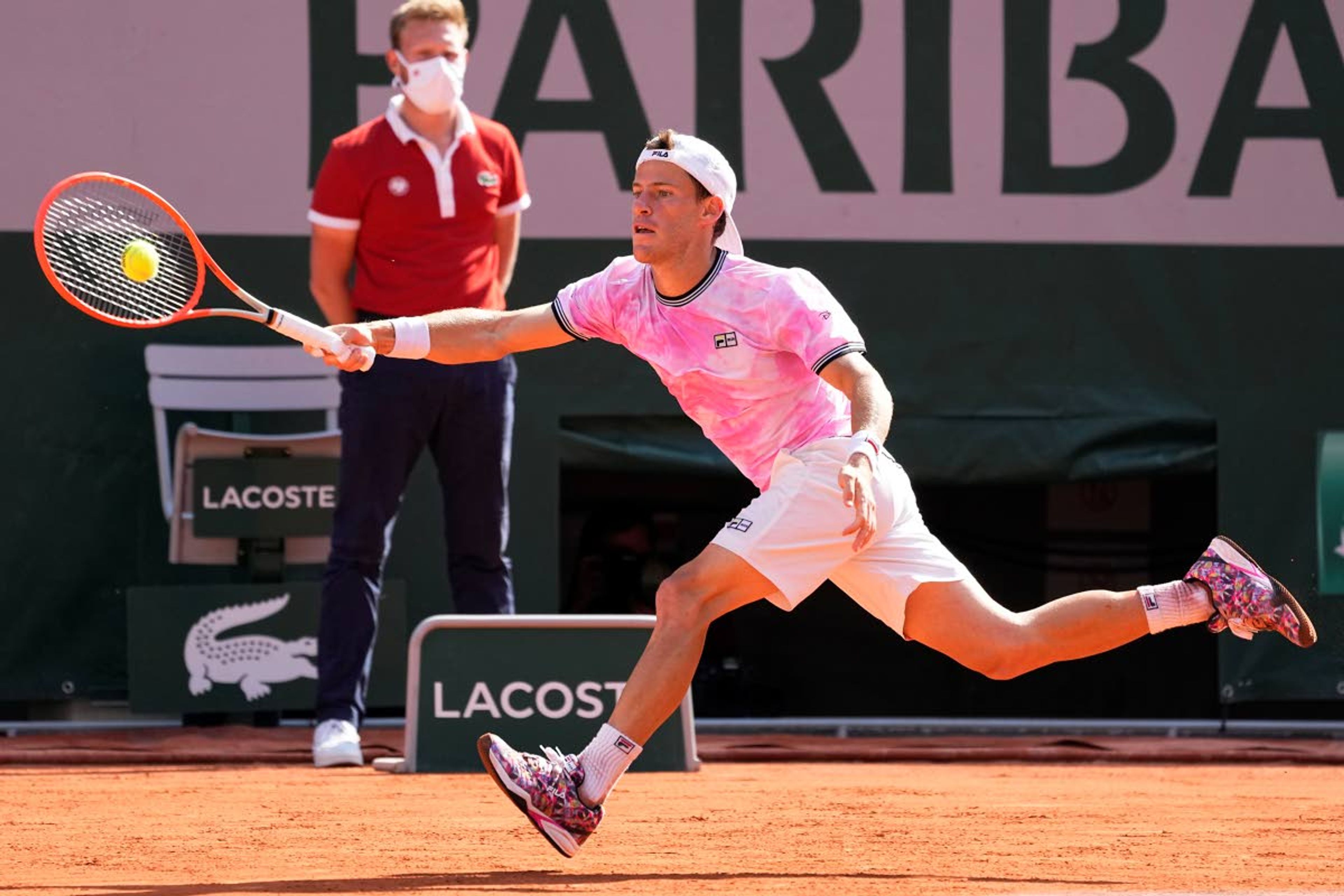 Argentina's Diego Schwartzman stretches to return the ball to Spain's Rafael Nadal during their quarterfinal match of the French Open tennis tournament at the Roland Garros stadium Wednesday, June 9, 2021 in Paris. (AP Photo/Michel Euler)