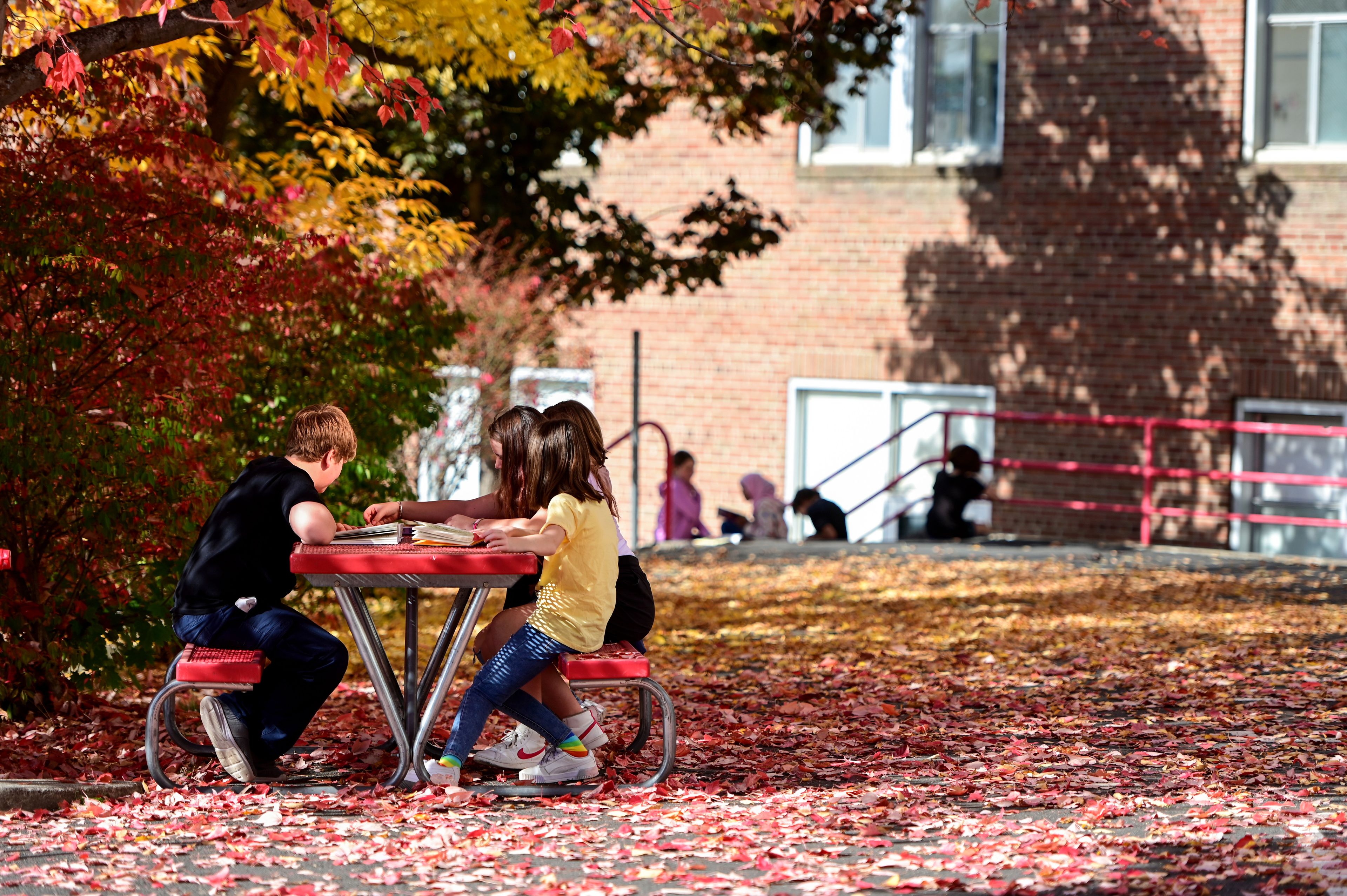 Fifth-grade students read outside of J. Russell Elementary School on Friday in Moscow. The students at the school raised more than $5,000 in a recent fundraiser, and a portion of those funds will be utilized for flexible seating in classrooms.