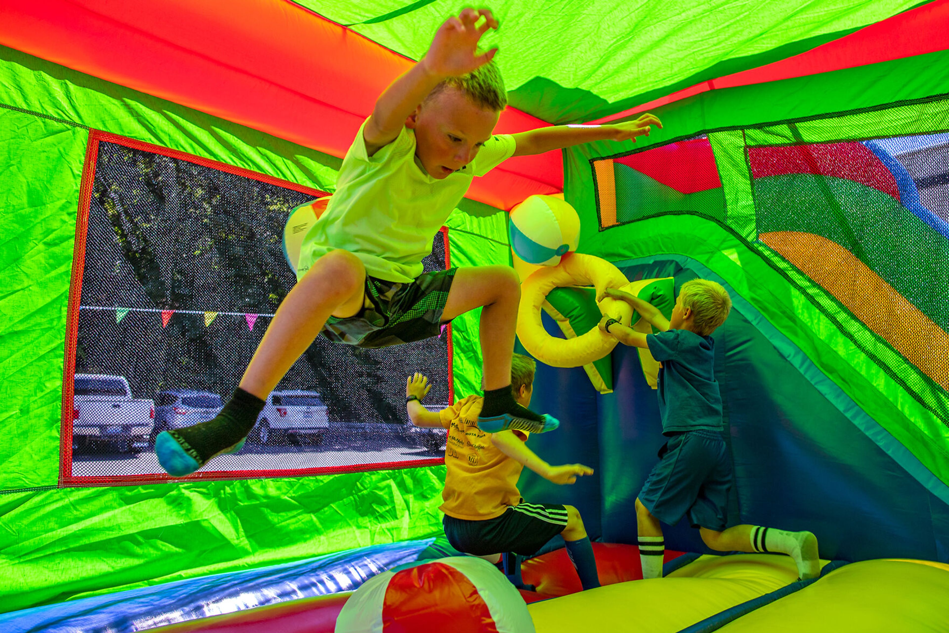 Hudson Inman, 6, of Colfax gets airborne in a bouncy castle Saturday during the city of Colfax’s 150th birthday celebration.,