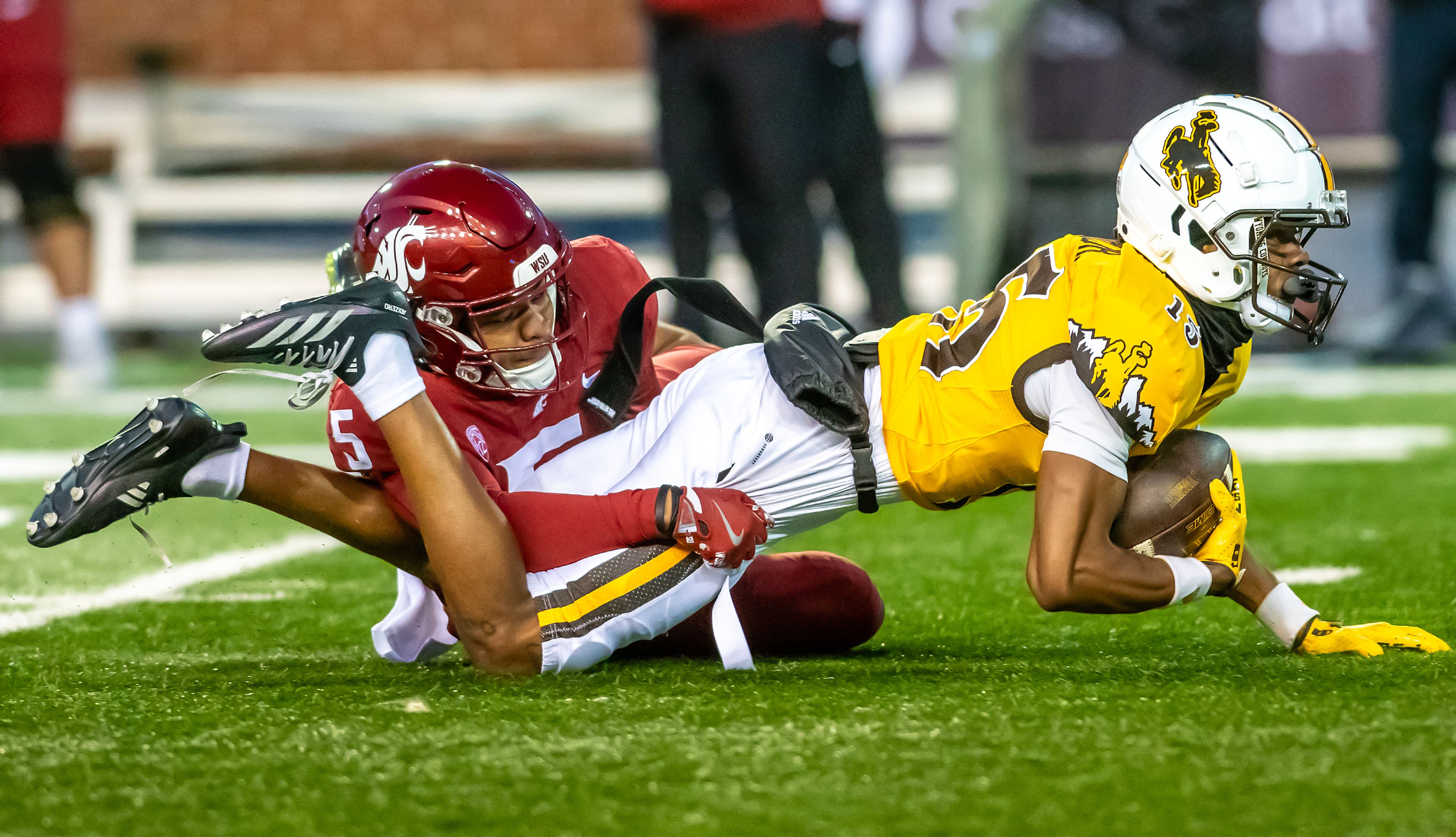 Washington State defensive back Tyson Durant brings down Wyoming wide receiver Tyler King after King pulled down a pass during a quarter of a college football game on Saturday, at Gesa Field in Pullman.