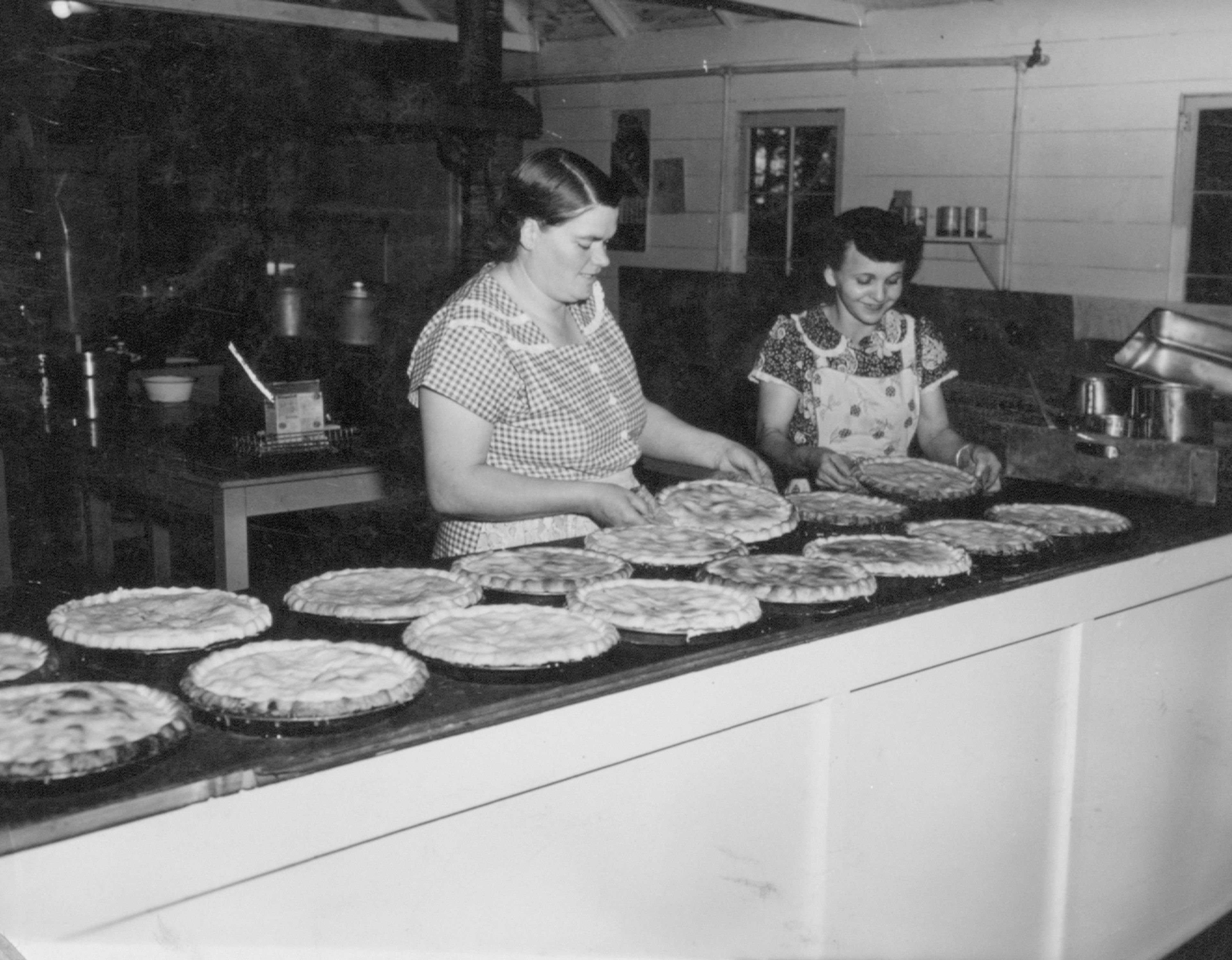 Marge Leinum and an unnamed fellow labber bake pies at the 1950 Chatcolab.