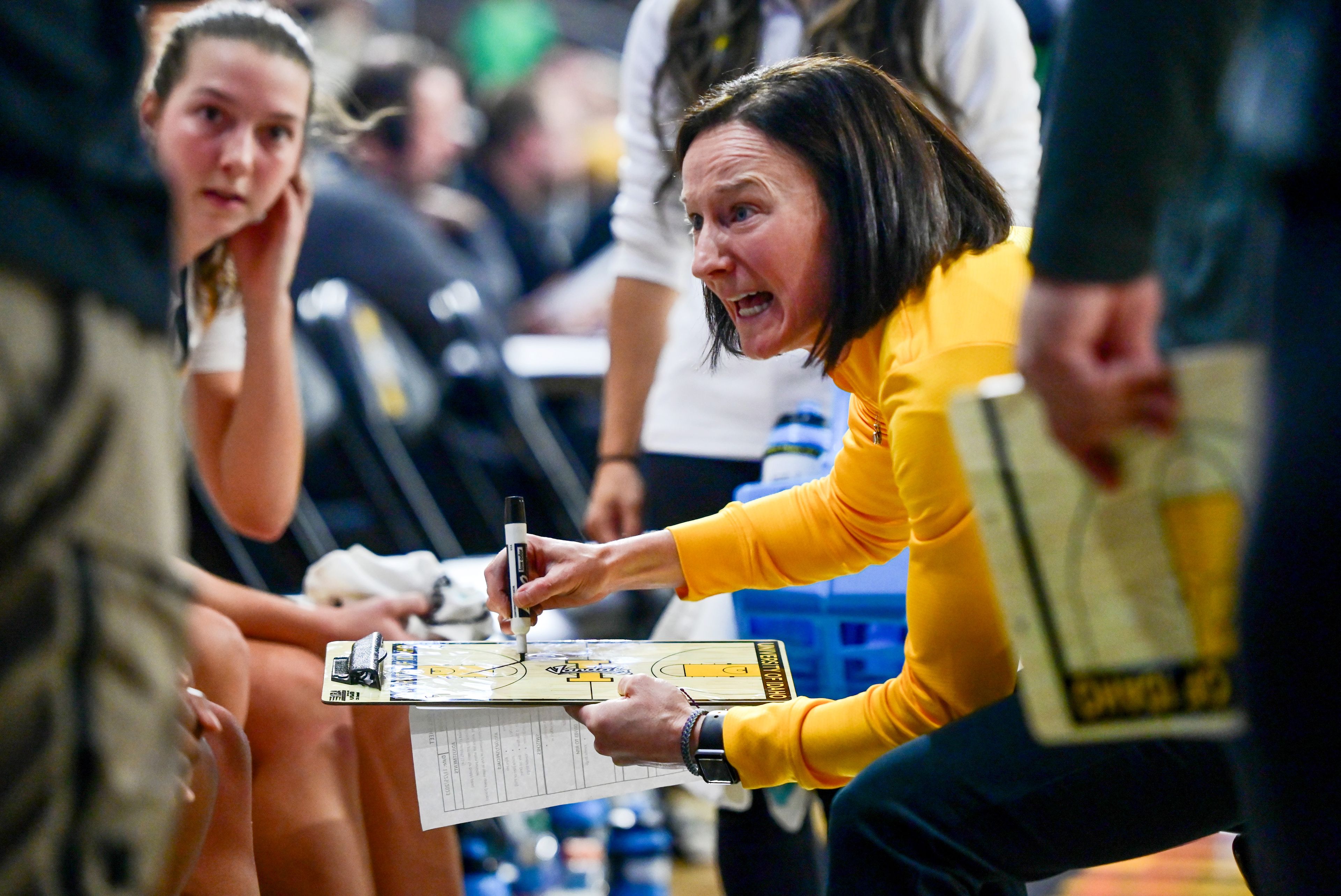 Idaho Vandals head coach Carrie Eighmey strategizes with the team before the fourth quarter of a game against Utah Valley on Nov. 23 at ICCU Arena in Moscow.