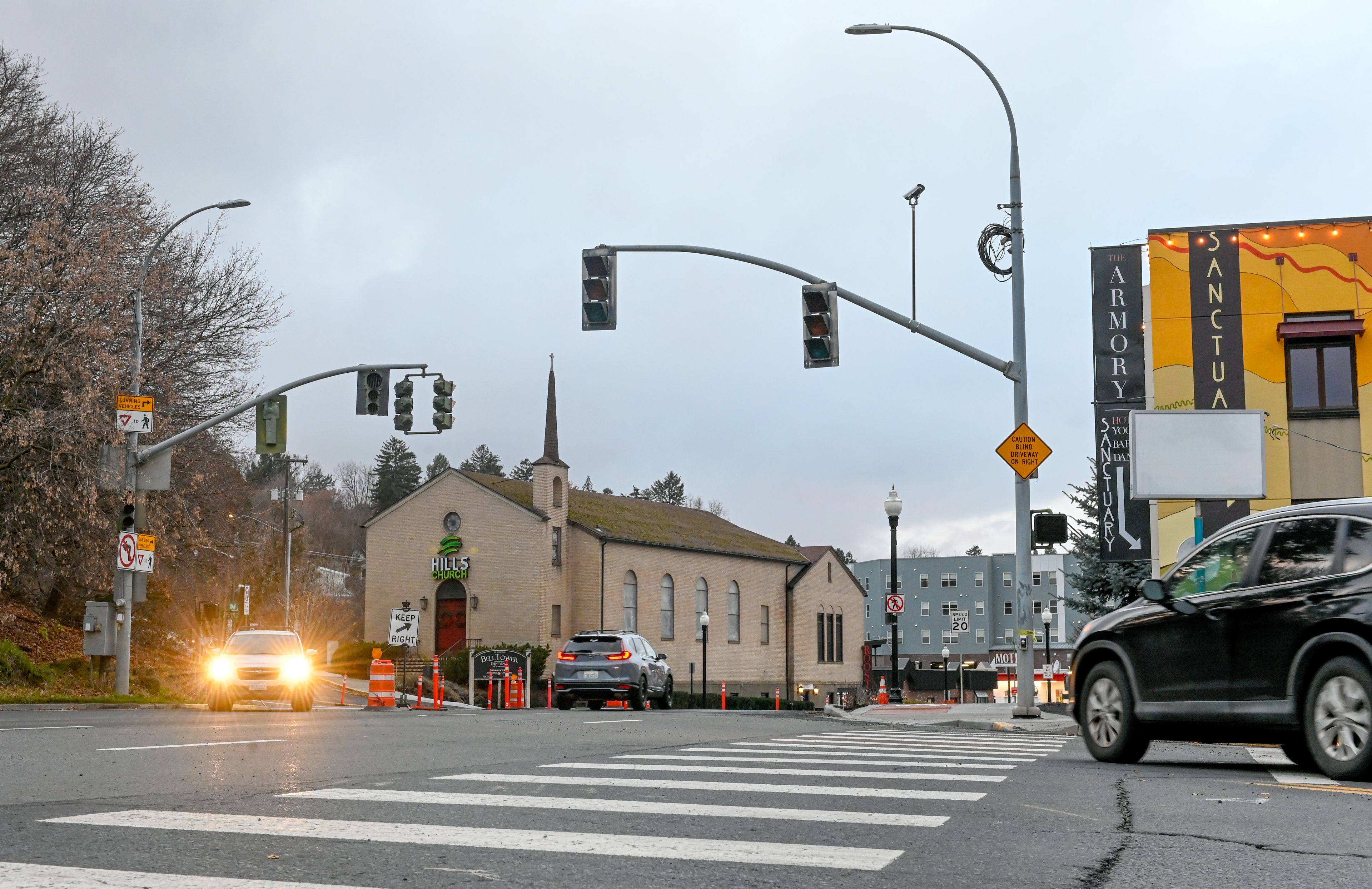 Cars pass through the intersection of Main and Spring streets Wednesday in Pullman. Permanent signals at the intersection are now not expected until January, developers shared Wednesday.