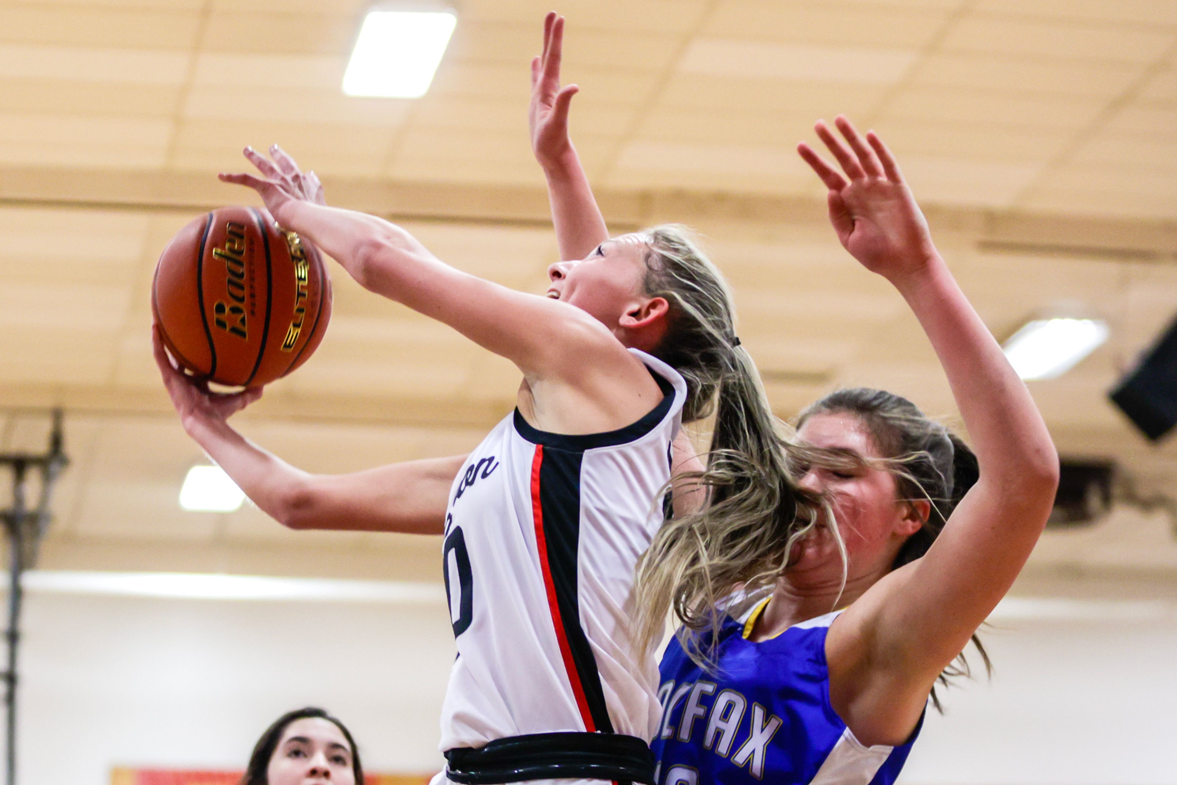 Clarkston wing/post Eloise Teasley goes up for a shot as Colfax post Brynn McGaughy guards her in a quarter of a nonleague game Thursday at Clarkston.