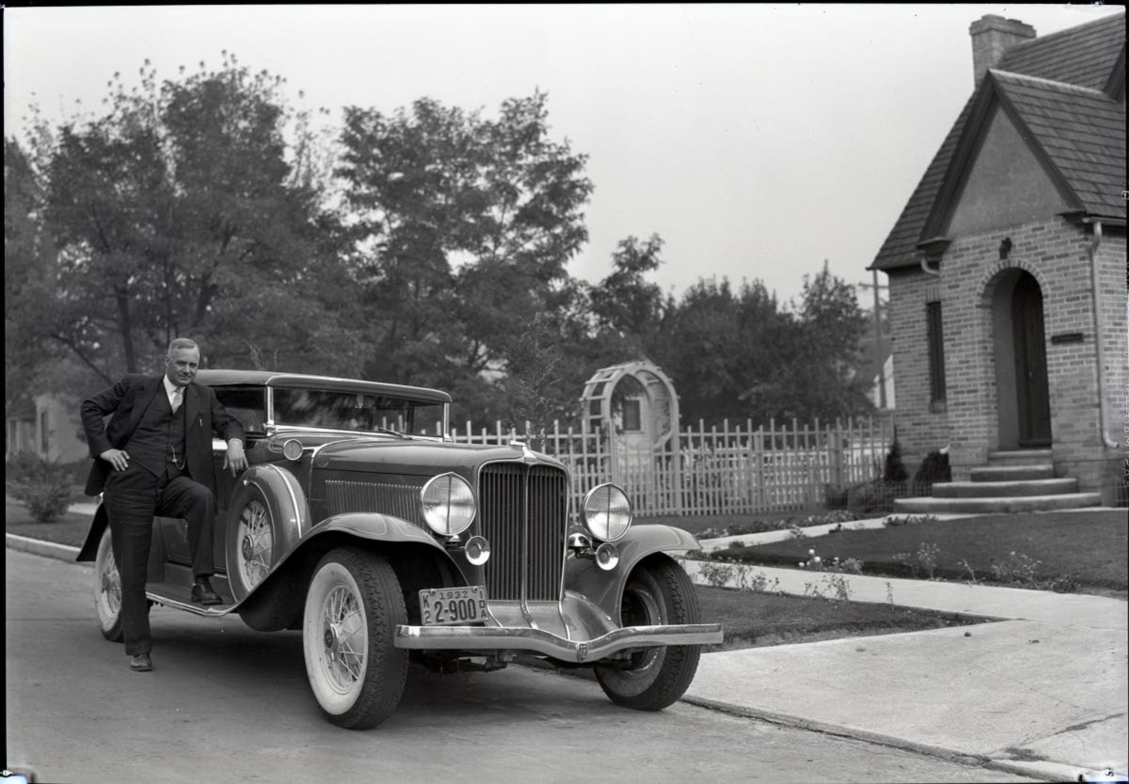 Frank Robinson drove fancy cars, evidence he said that his teachings worked. He’s pictured here with an Auburn in the early 1930s, outside his Howard Street home.