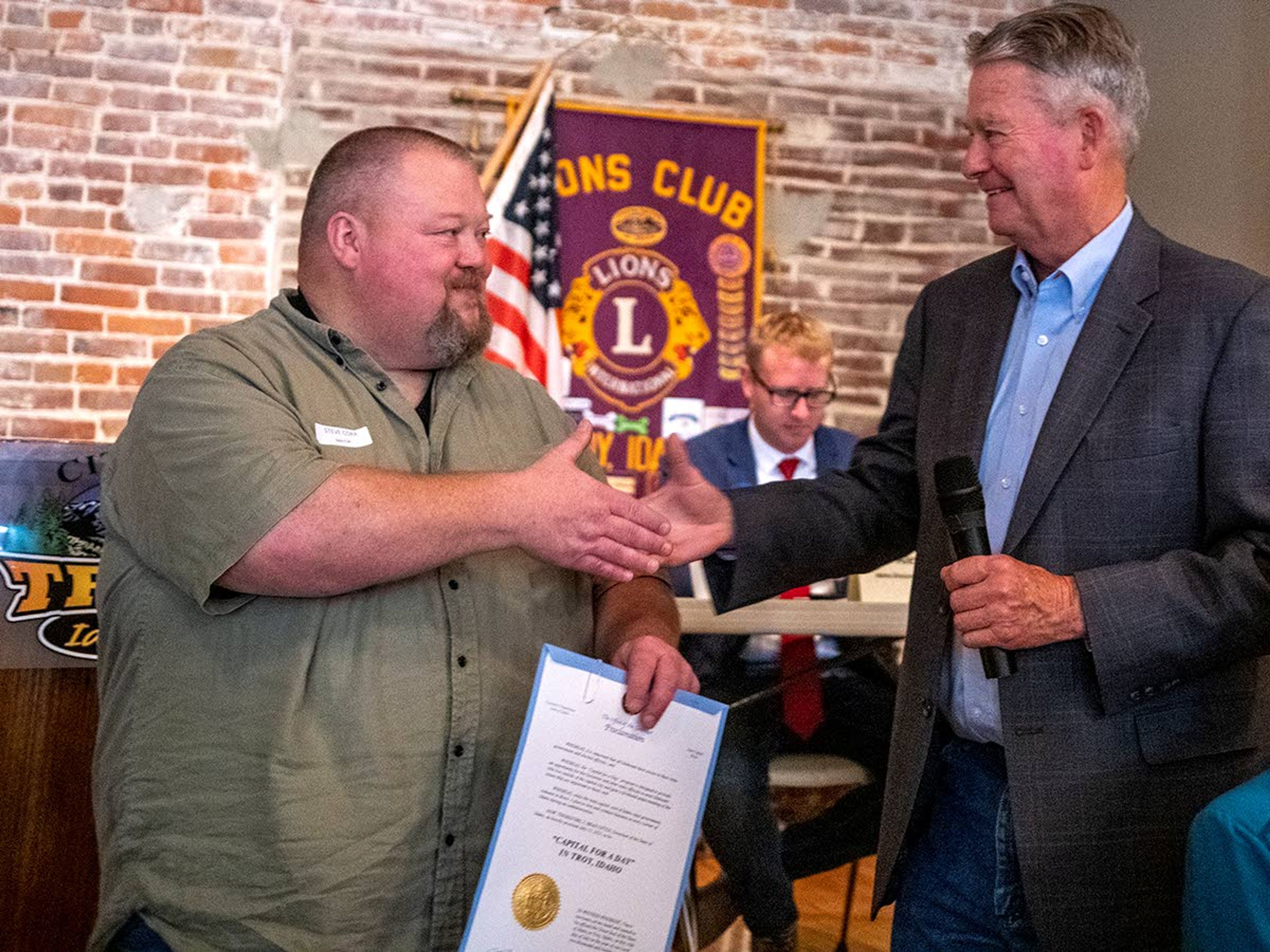 Mayor Steve Corr, of Troy, shakes hands with Idaho Gov. Brad Little after proclaiming Troy as the state “Capital for a Day” on Thursday afternoon at Troy’s Lions Club.