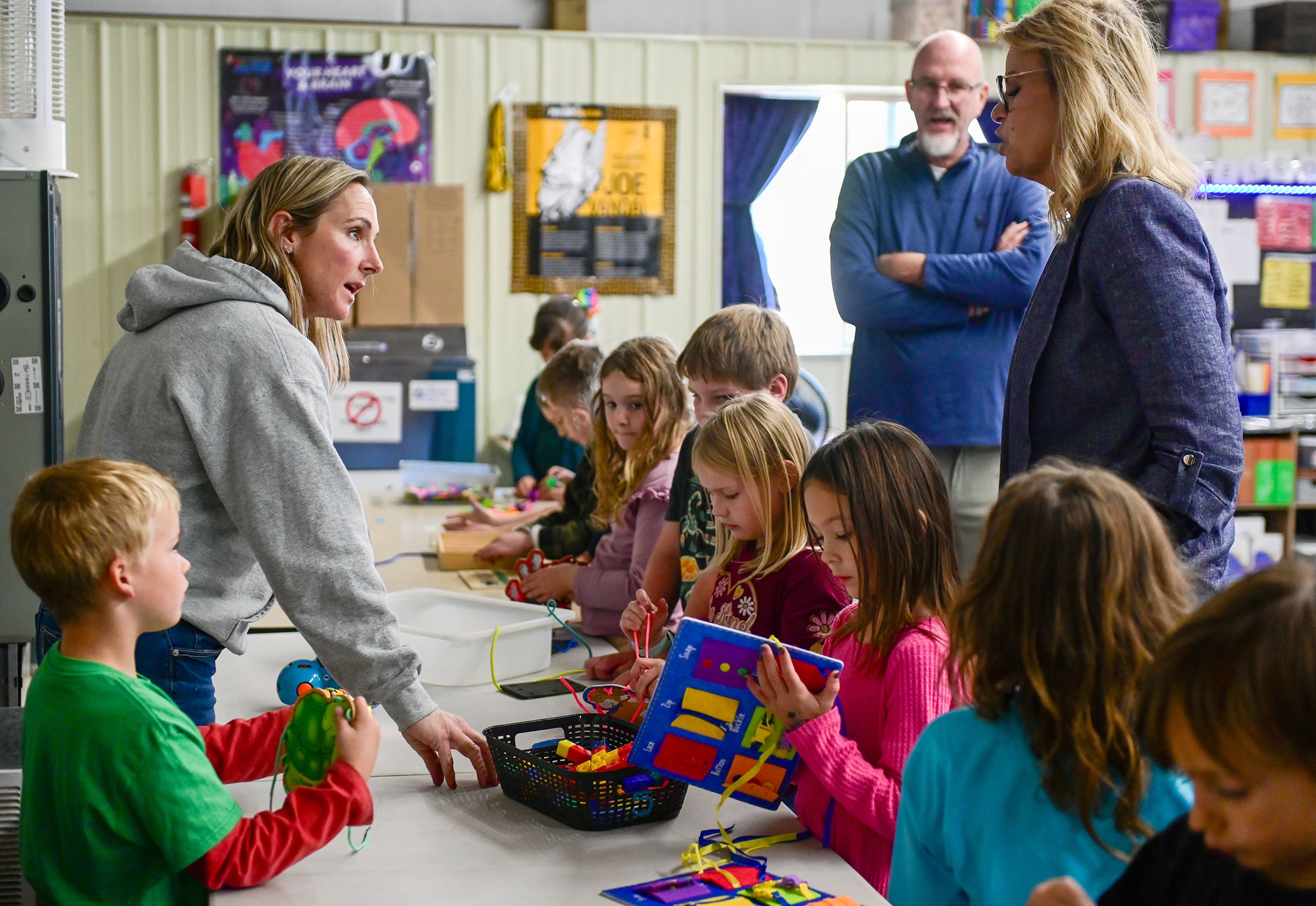 Cat Harner, left, Moscow Charter School elementary physical education, keyboarding and robotics teacher, speaks with Idaho Superintendent of Public Instruction Debbie Critchfield, right, during Critchfields tour of the school Friday in Moscow.