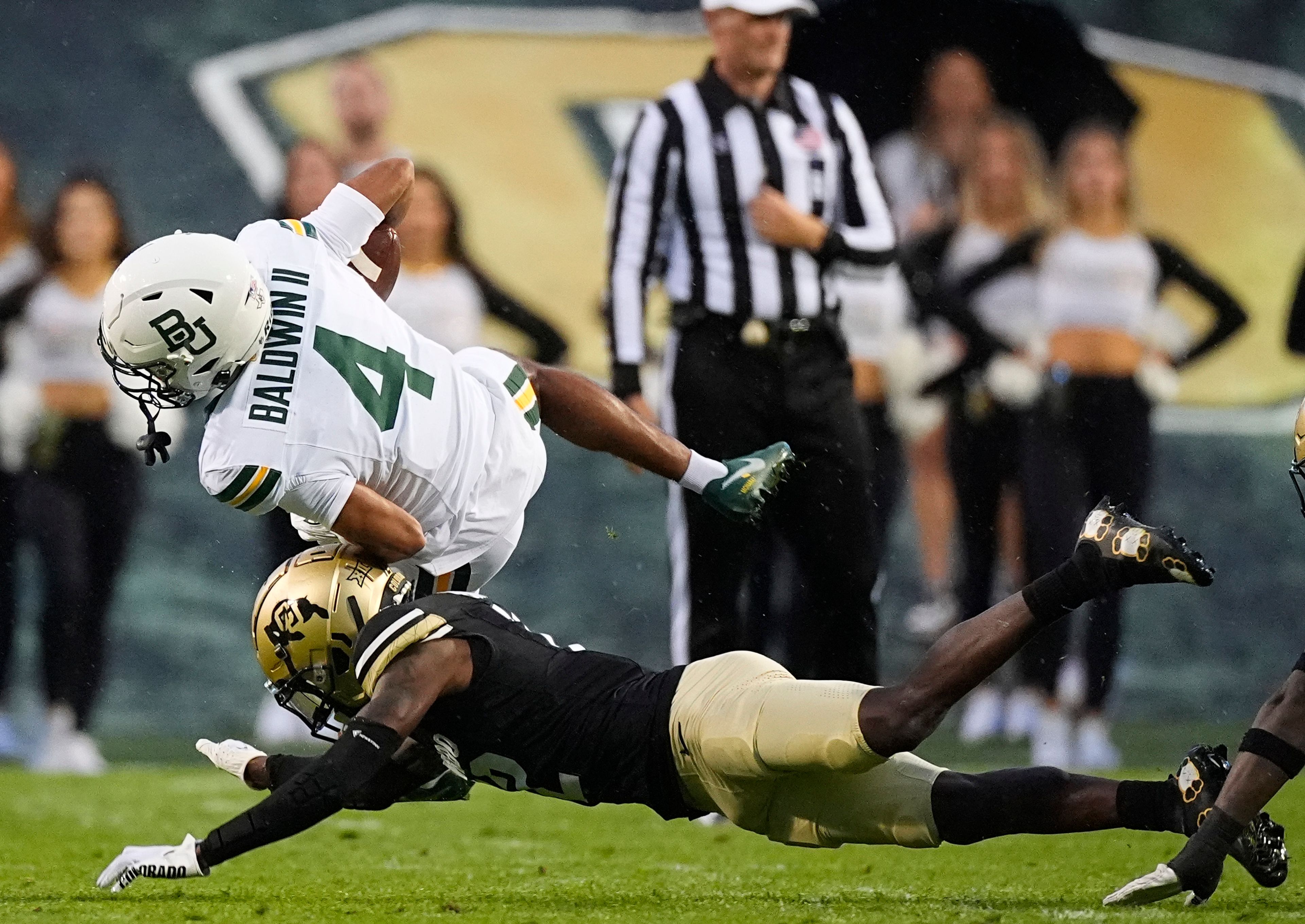 Colorado defensive back Travis Hunter, bottom, stops Baylor wide receiver Monaray Baldwin after catching a pass for a short gain in the first half of an NCAA college football game Saturday, Sept. 21, 2024, in Boulder, Colo. (AP Photo/David Zalubowski)