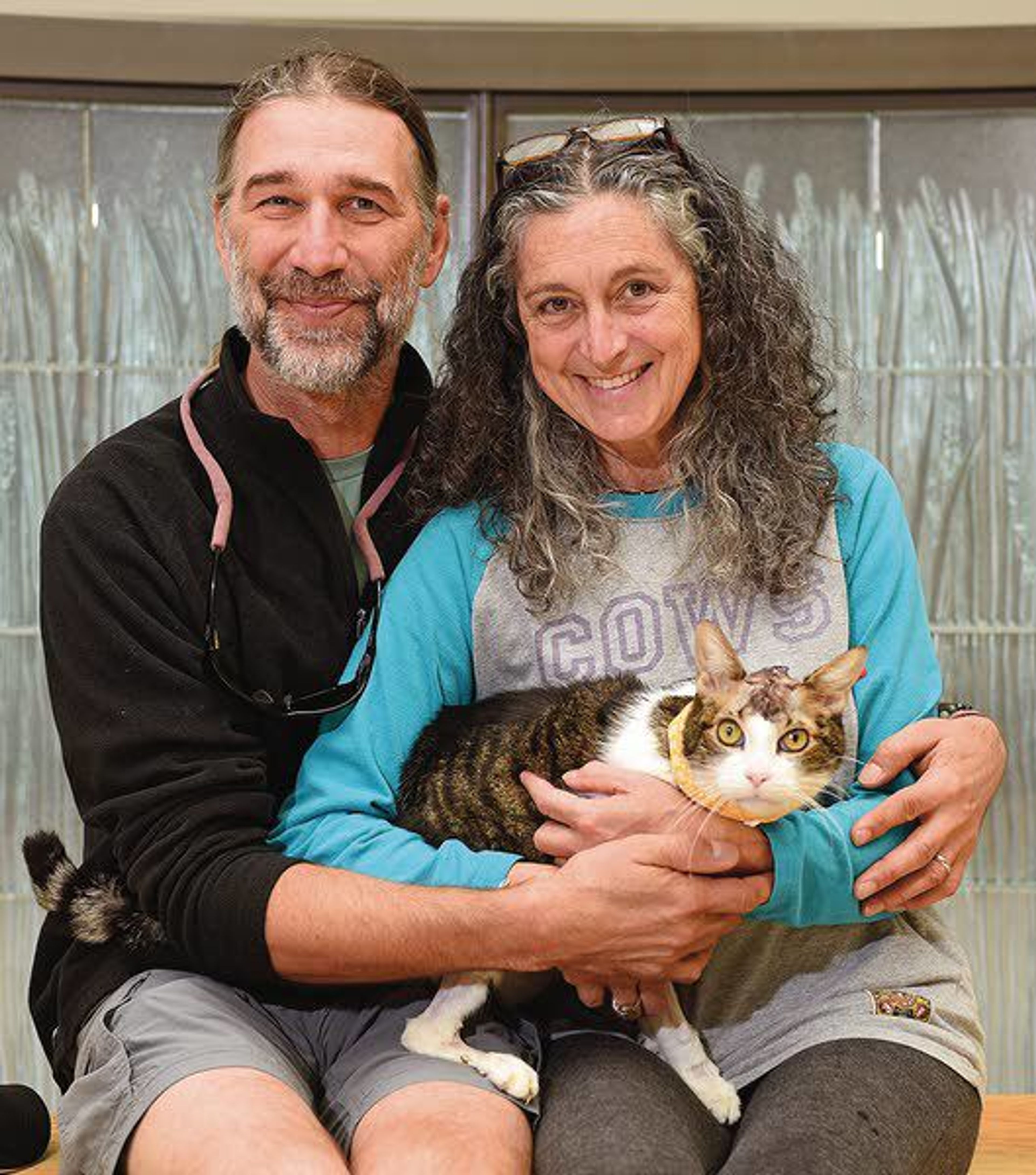 Owners Holly Freifeld and David Leonard hold their cat, Linus, in Set., 2018.