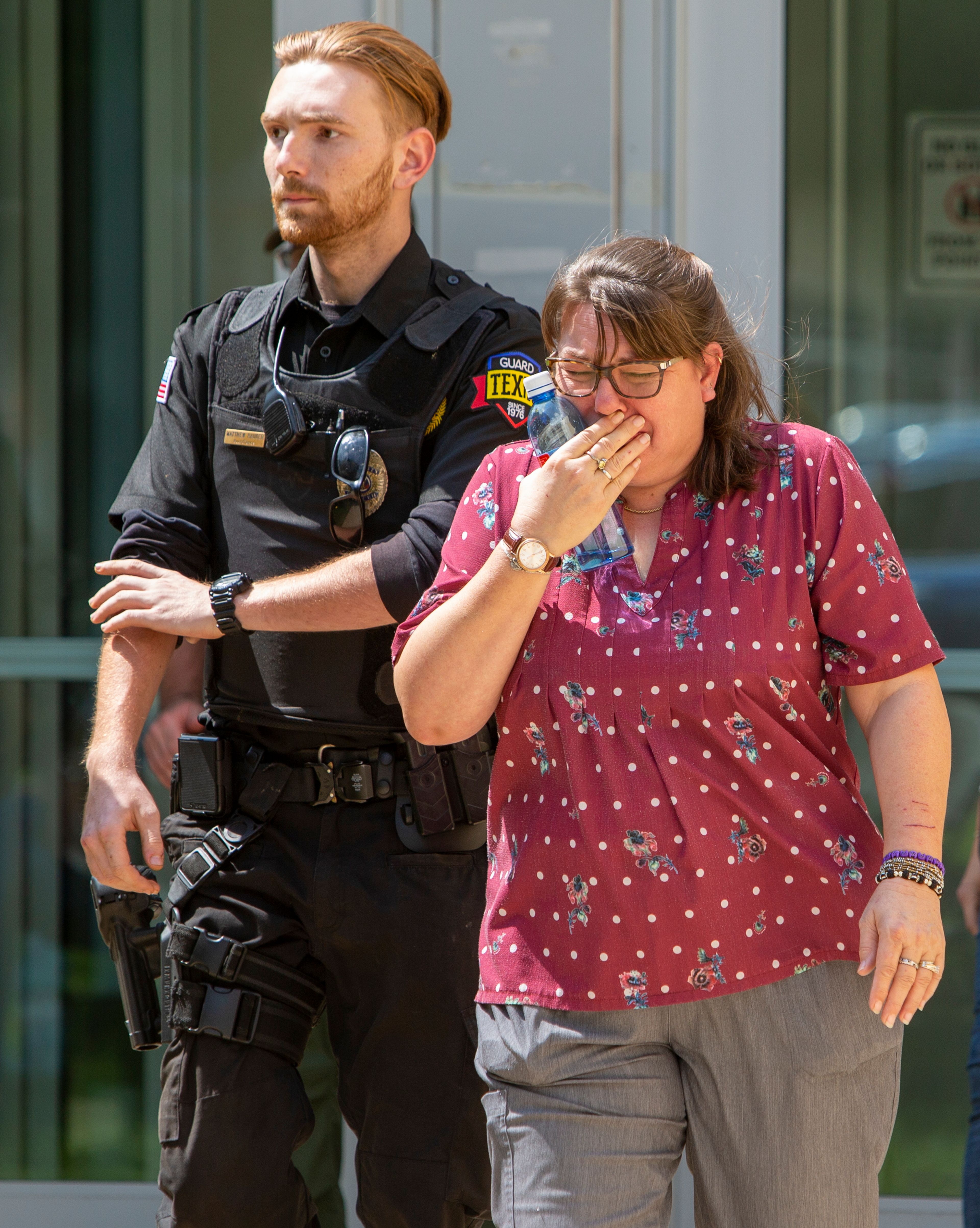 A woman cries as she leave the Uvalde Civic Center following a shooting earlier in the day at Robb Elementary School, Tuesday, May 24, 2022, in Uvalde, Texas. (William Luther/The San Antonio Express-News via AP)