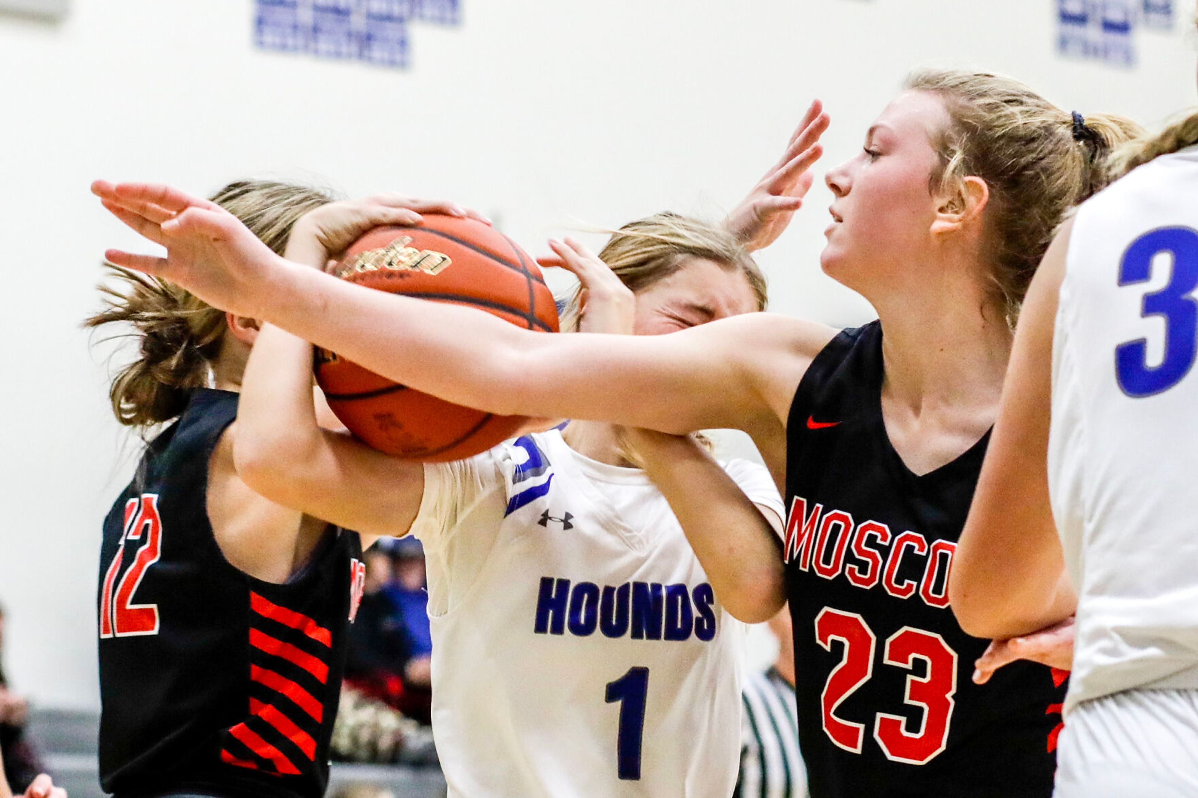 Pullman guard Megan Limburg, center, struggles to hold onto the ball as Moscow forward Jessa Skinner, right, and guard Kennedy Thompson defend during Saturday's nonleague girls basketball game.