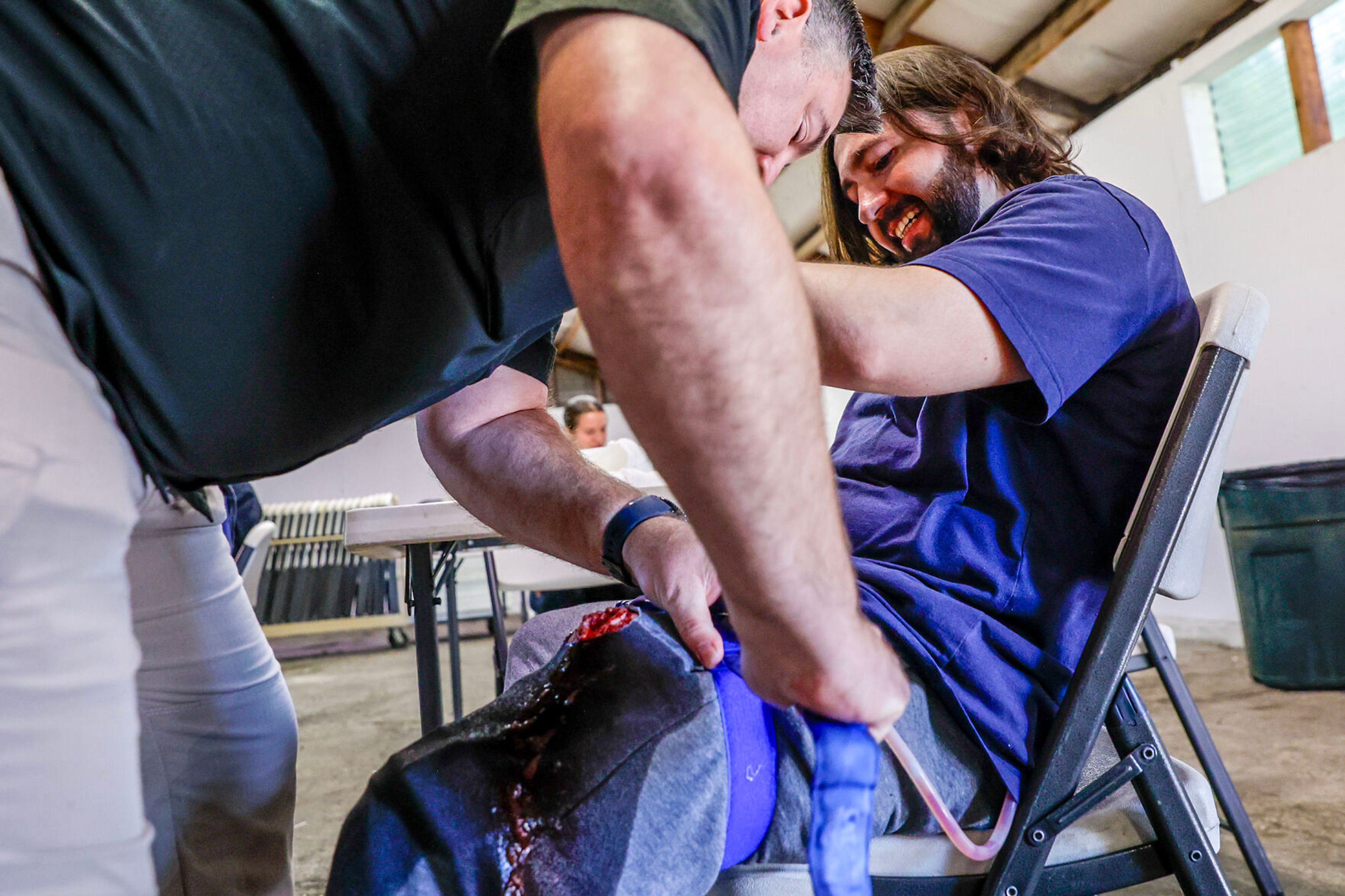 Alex Gelinas has a tourniquet applied to his leg spurting blood during a disaster simulation of a windstorm Saturday at the Latah County Fairgrounds.