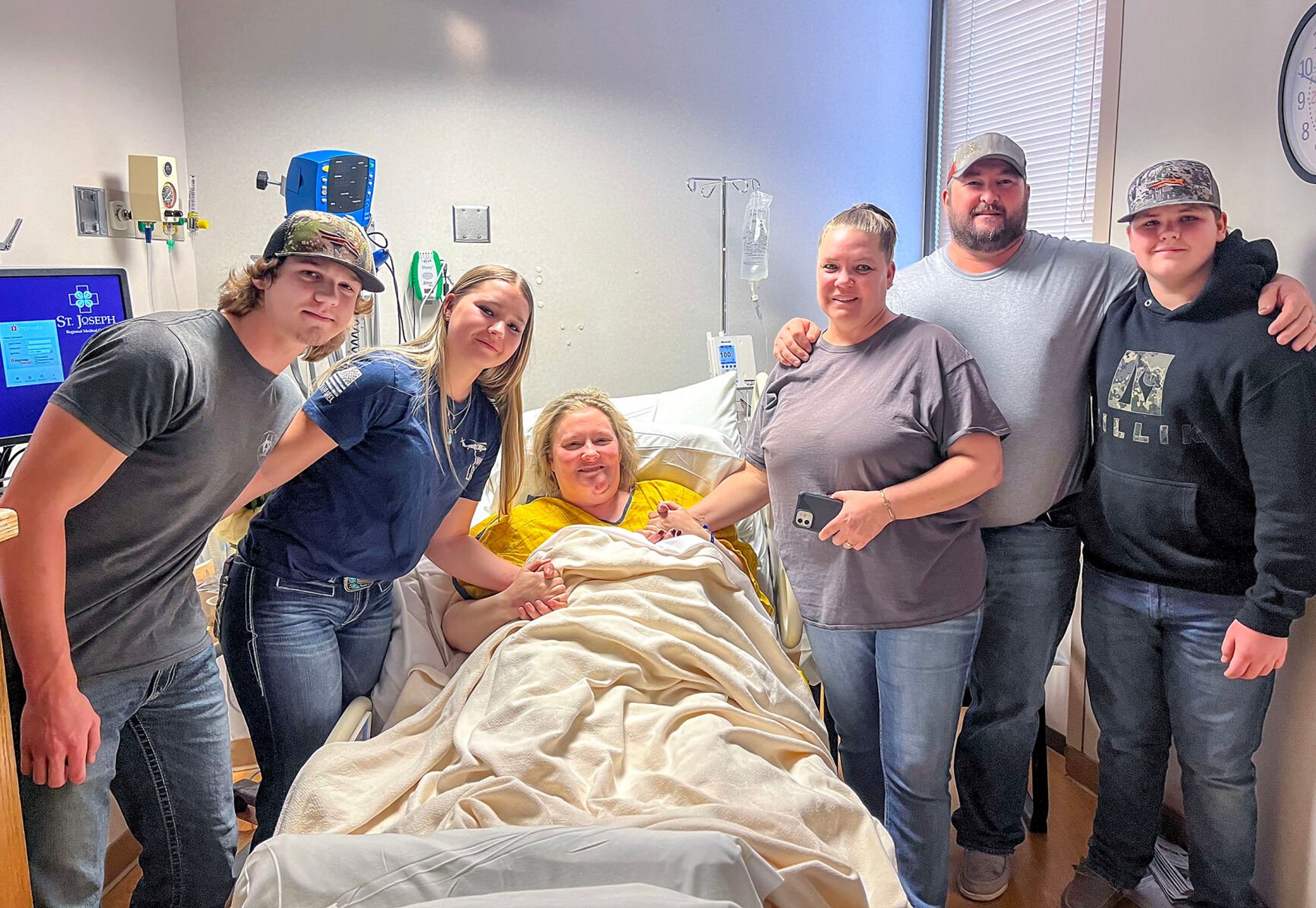 Tyler Slaybaugh, from left, Kylee Montague, Kristen Blackburn, Lisa Montague, Justin Montague and Trevor Montague are pictured in Kristen’s hospital room at St. Joseph Regional Medical Center in Lewiston.