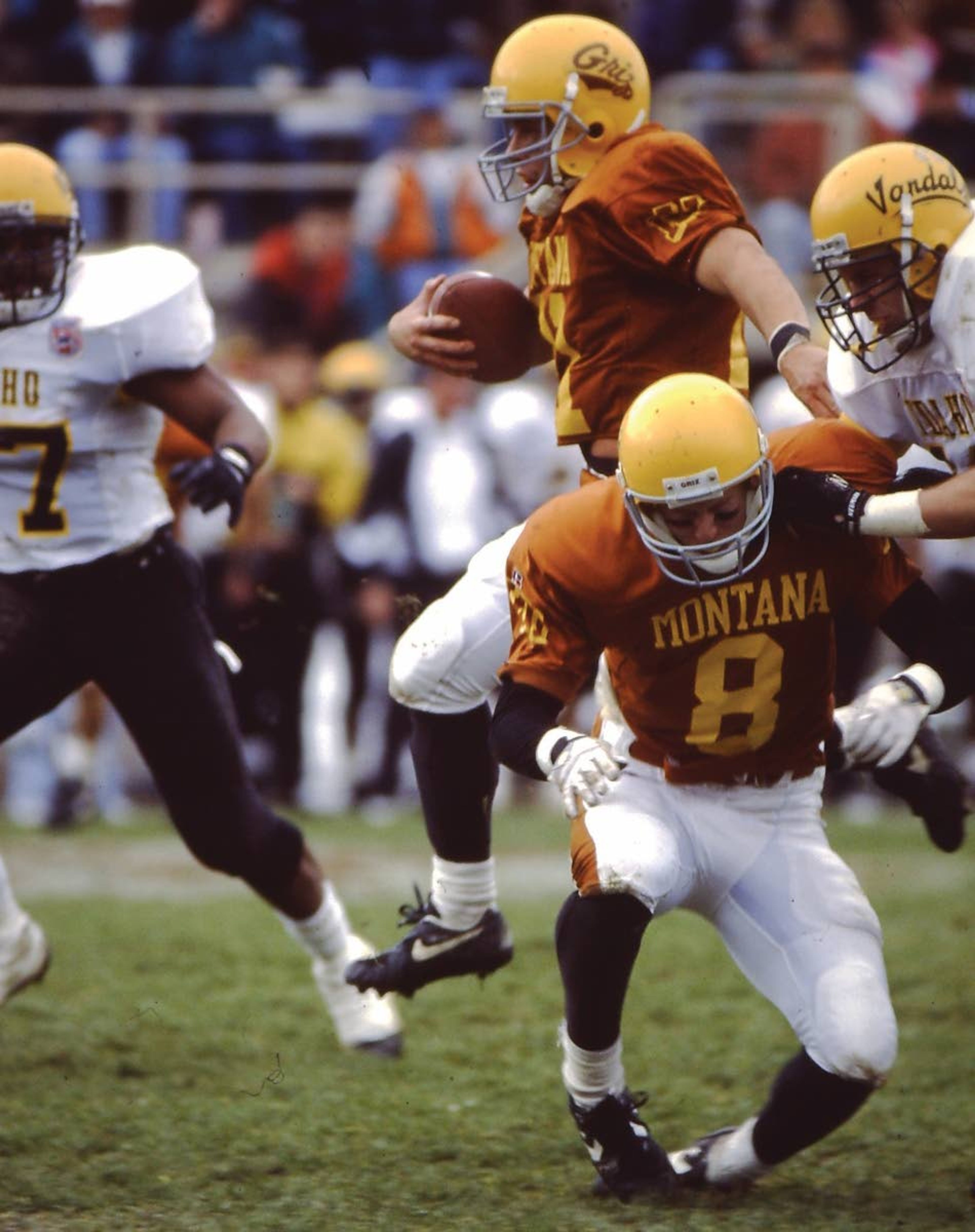 Montana Athletics Montana quarterback Dave Dickenson (with ball) runs during the game against Idaho in 1994.