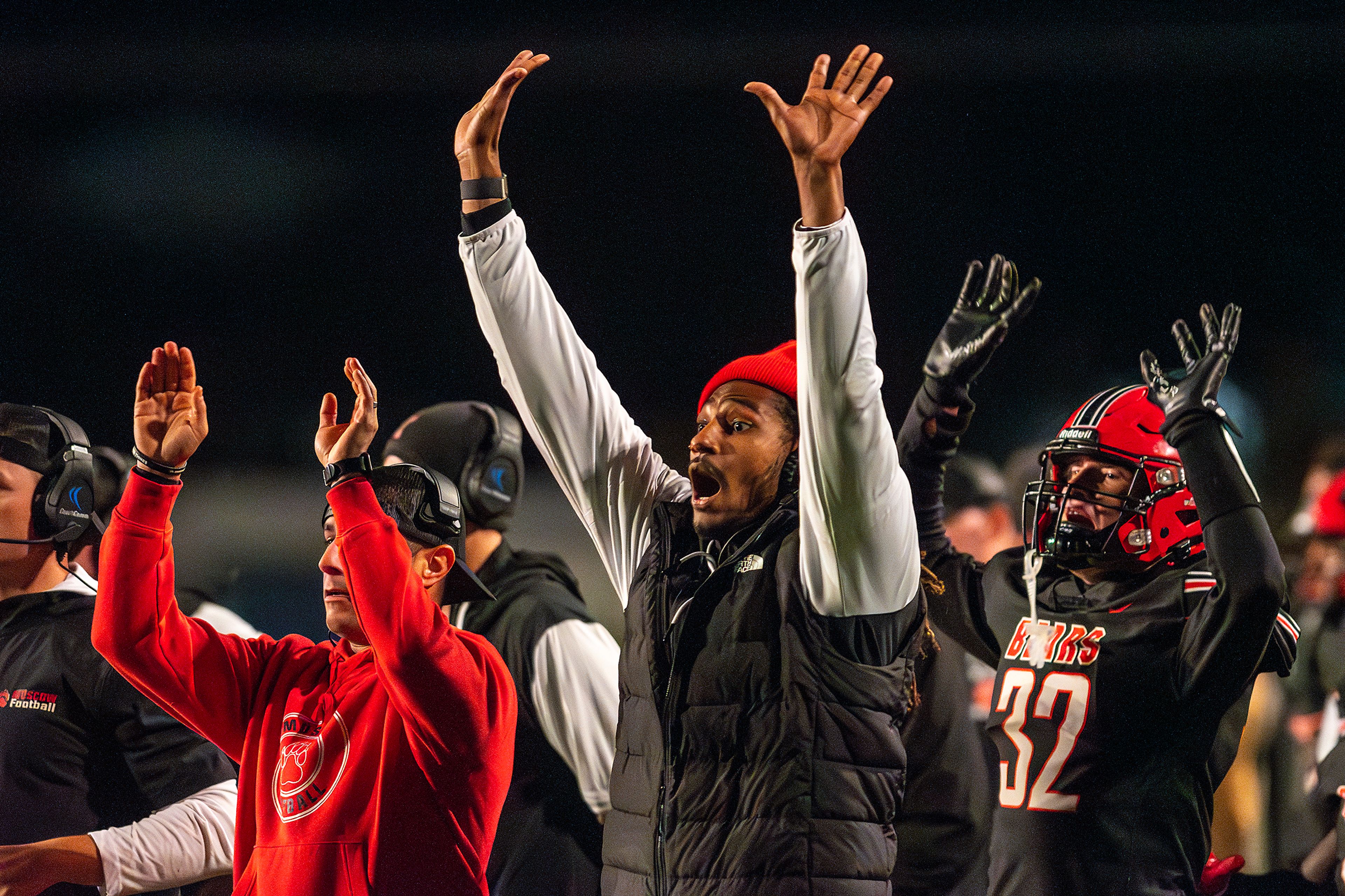 The Moscow sideline gestures to their players on the field during an Idaho 4A playoff game Friday in Moscow.