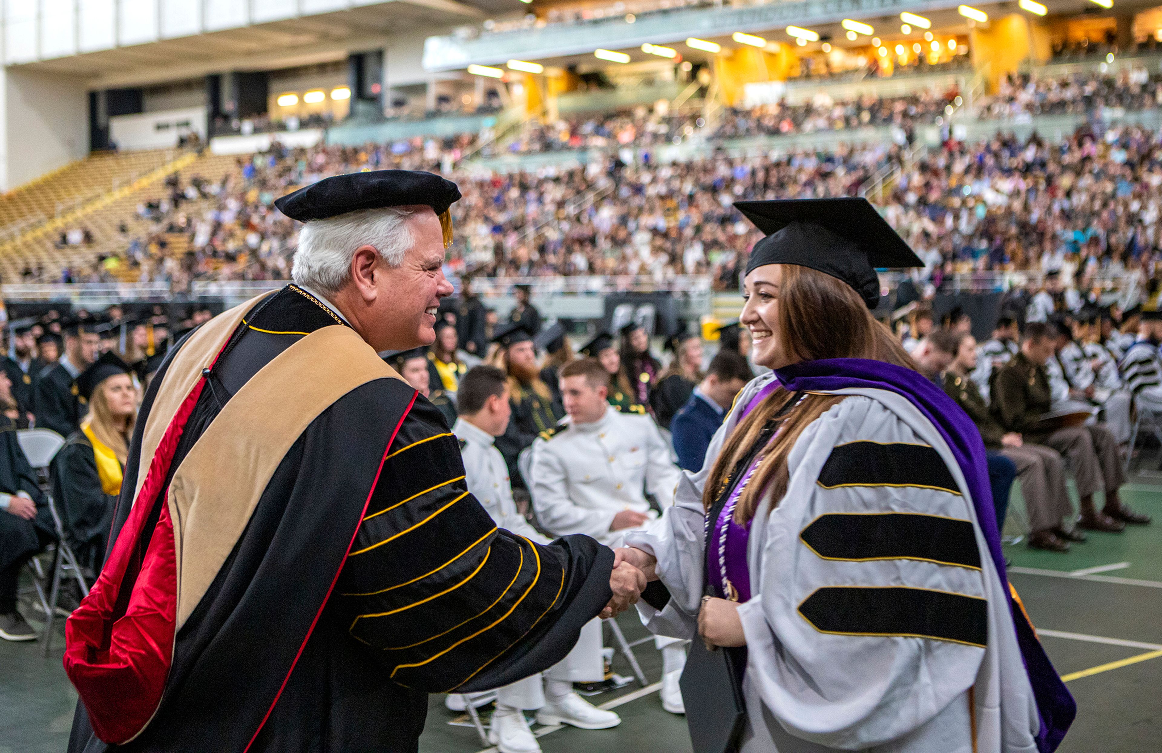 University of Idaho President C. Scott Green shakes hands with law school graduate Alexis Hoech as she exits the stage Saturday morning during the University of Idaho's 2022 Spring Commencement Ceremony at the Kibbie Dome in Moscow.