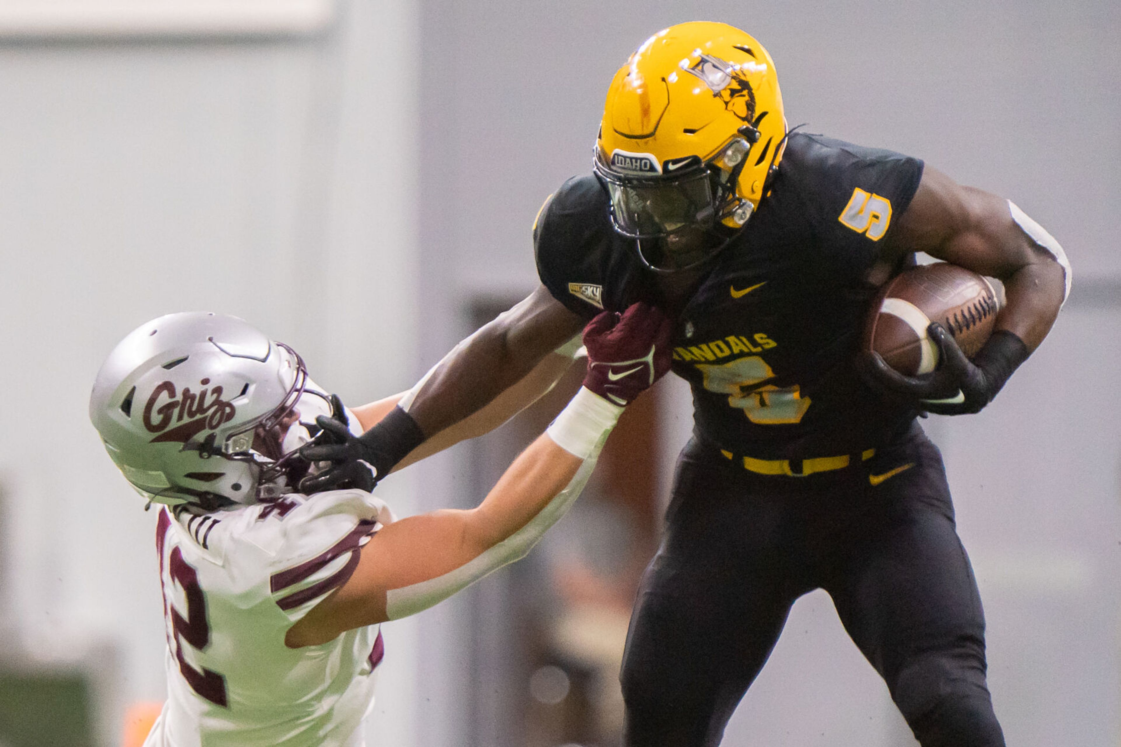 Idaho running back Anthony Woods (5) stiff arms Montana linebacker Riley Wilson (42) during a game inside the Kibbie Dome on Oct. 14 in Moscow.