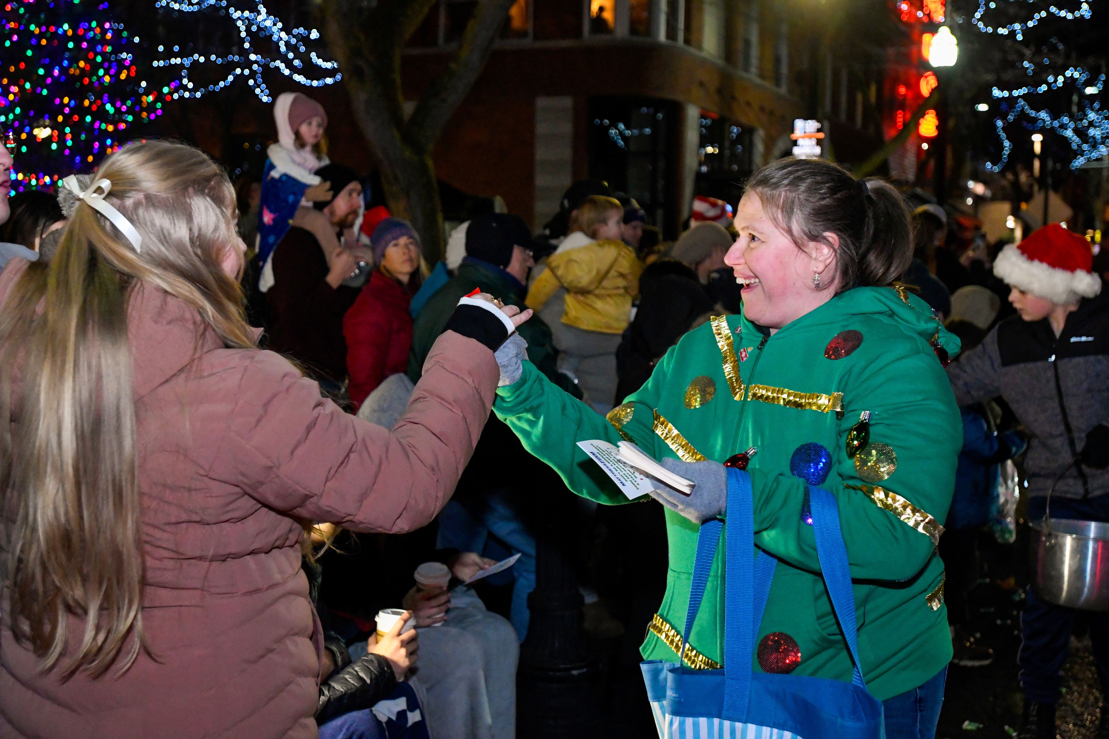 Those in the Light Up the Season parade interact with the crowd as they hand out candy and other items along Main Street on Thursday.