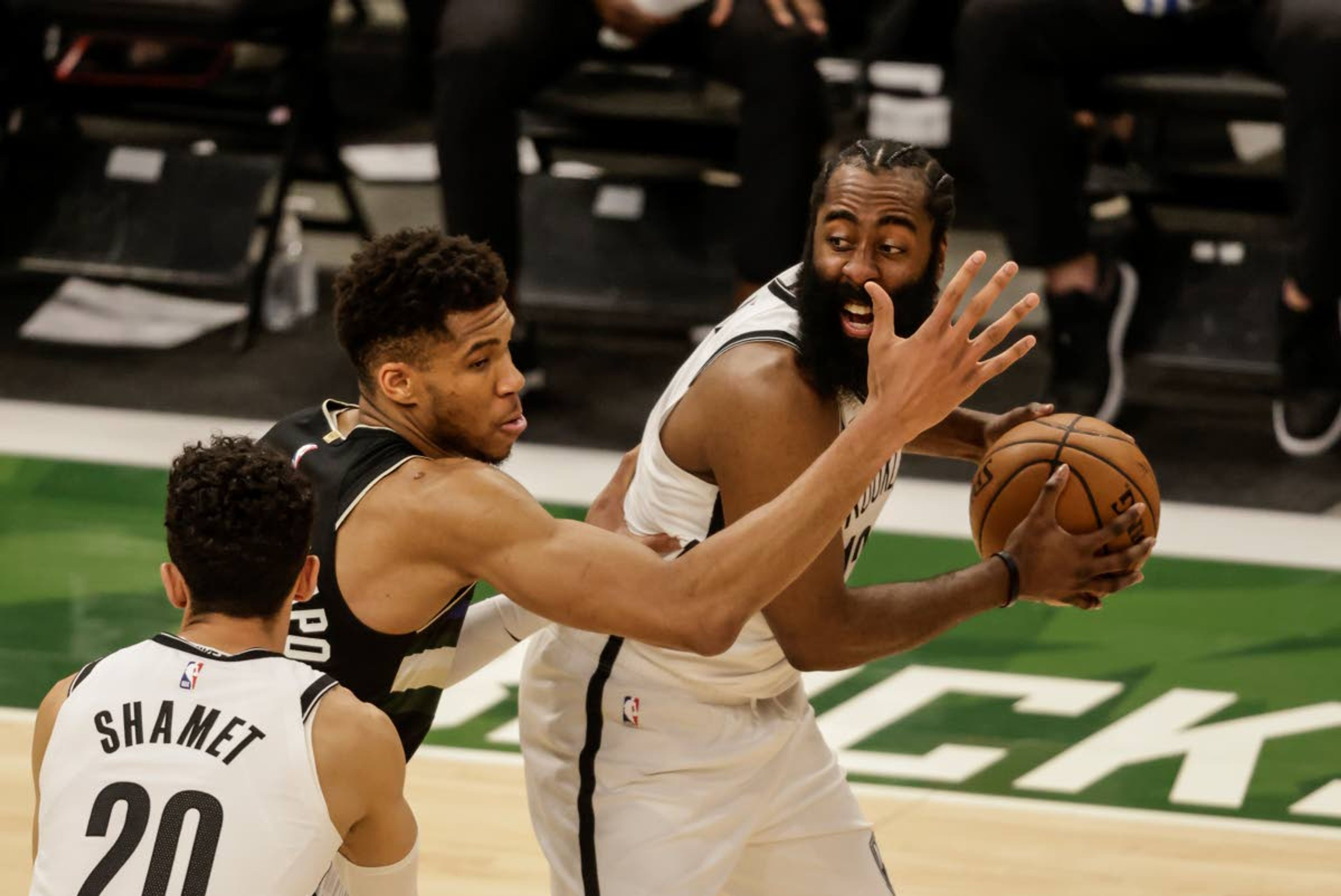 Associated PressThe Nets’ James Harden, right, is guarded by Bucks forward Giannis Antetokounmpo, center, during the first half of Game 6 of a second-round NBA basketball playoff series Thursday in Milwaukee.