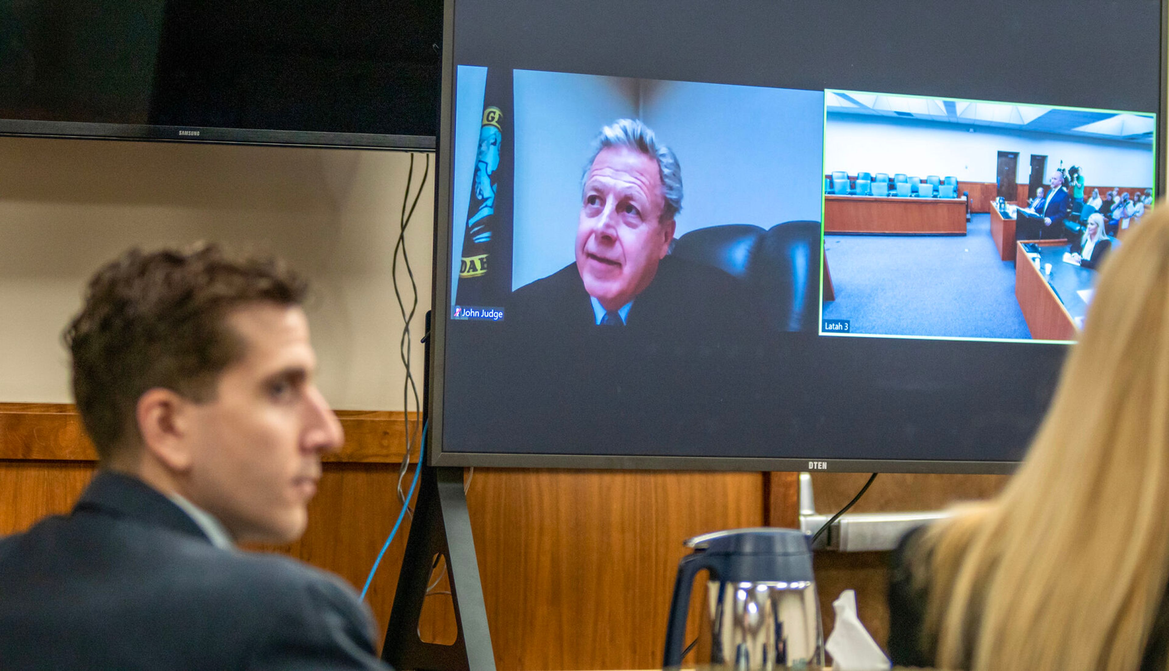 District Judge John Judge, on screen, listens to an oral argument Oct. 26, 2023, during a hearing for Bryan Kohberger, left, in this file photo.