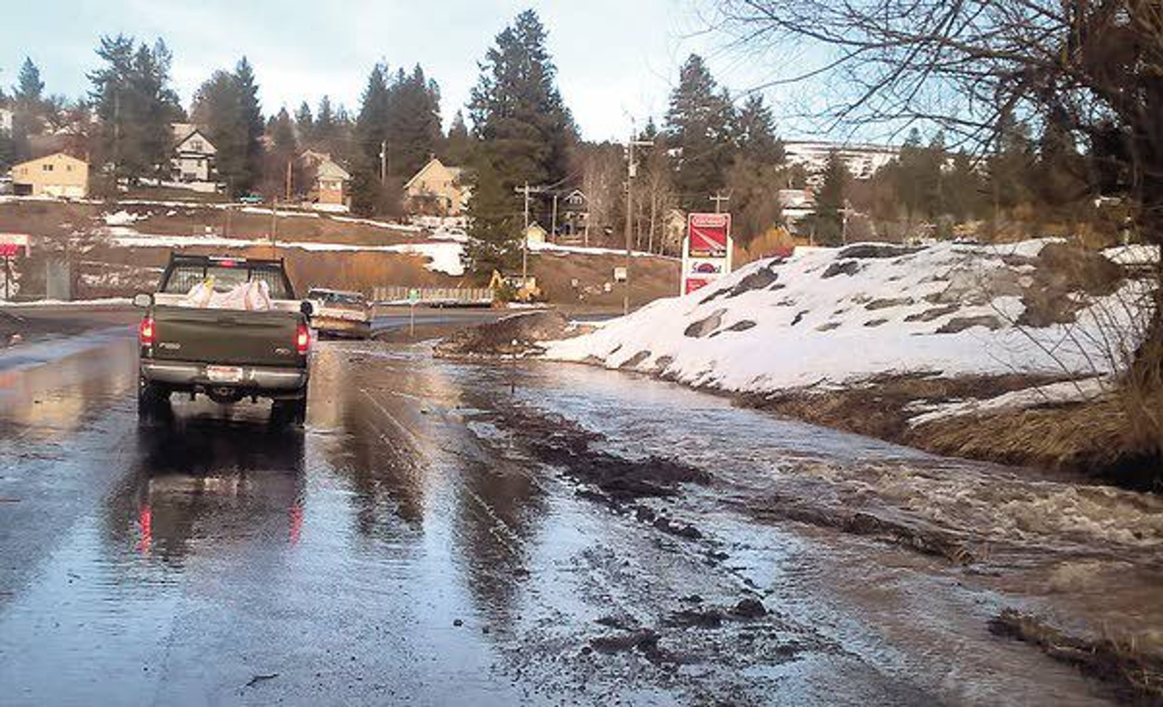 Water from a flooding creek spill onto Highway 8 on the west edge of Troy on Friday.