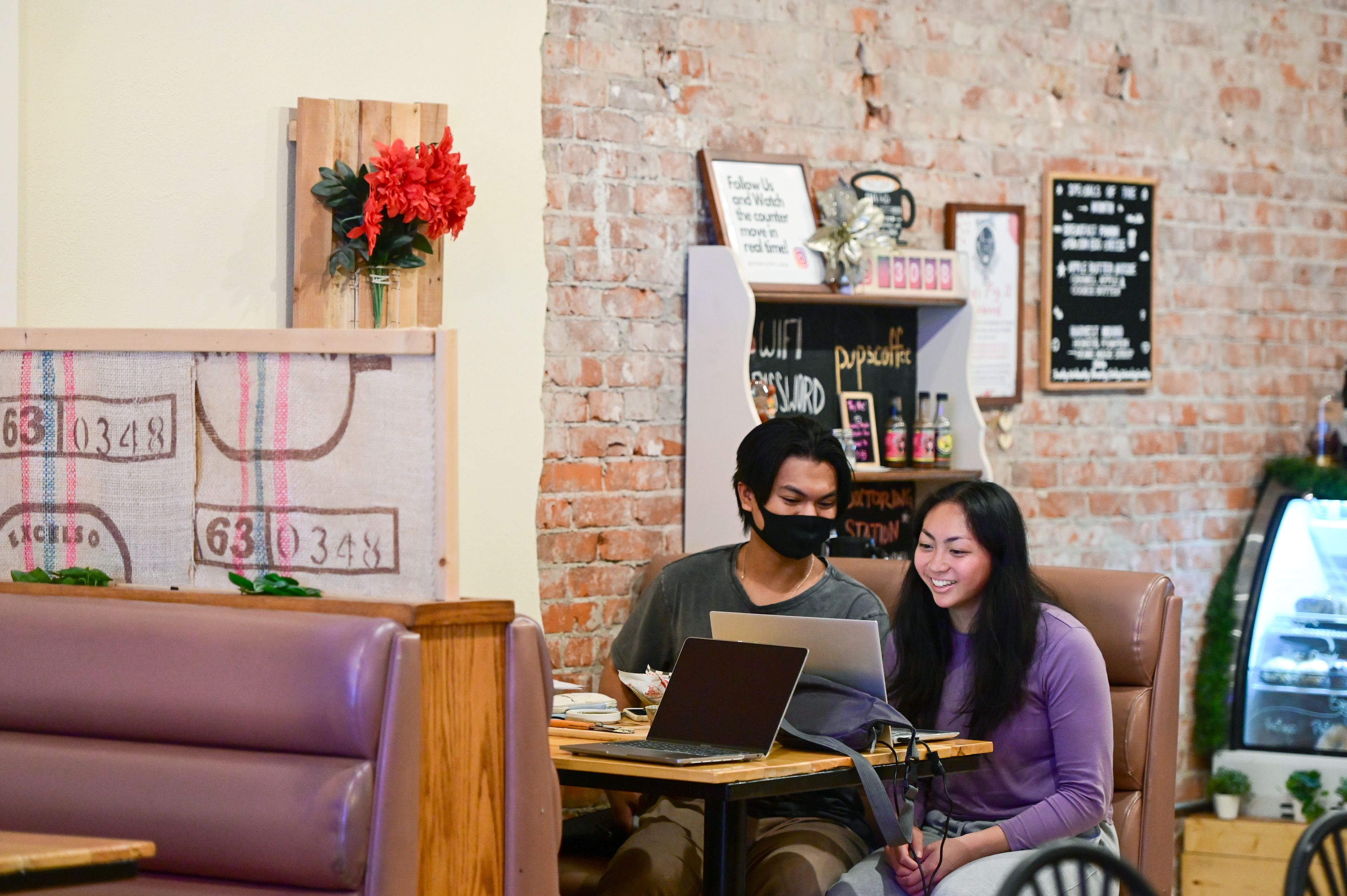 WSU students Gian Roque, left, and Natalie Camerino study together over lunch at Pups & Cups Cafe in downtown Pullman on Wednesday, Nov. 15.