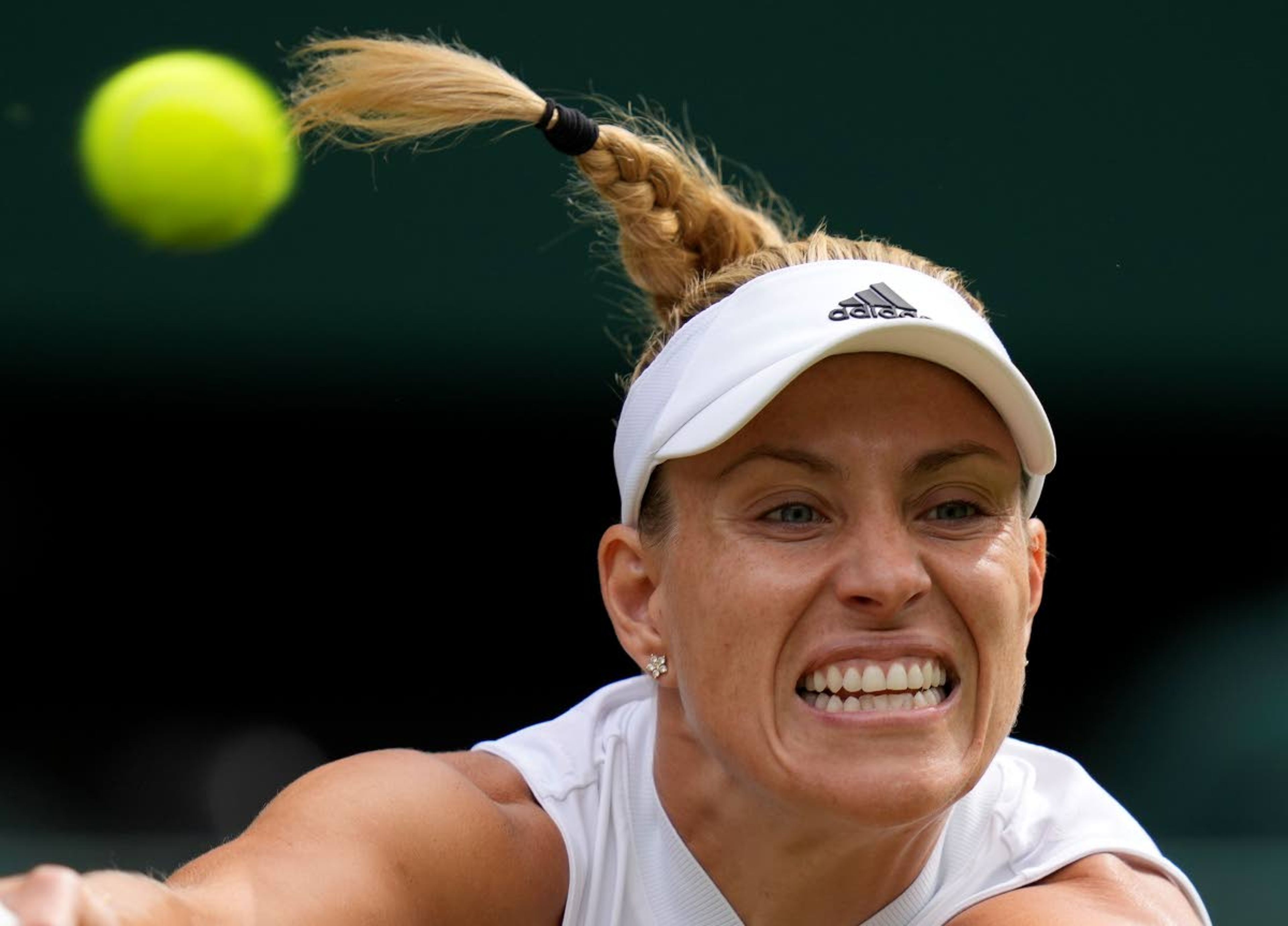 Germany's Angelique Kerber plays a return to Coco Gauff of the U.S. during the women's singles fourth round match on day seven of the Wimbledon Tennis Championships in London, Monday, July 5, 2021. (AP Photo/Kirsty Wigglesworth)