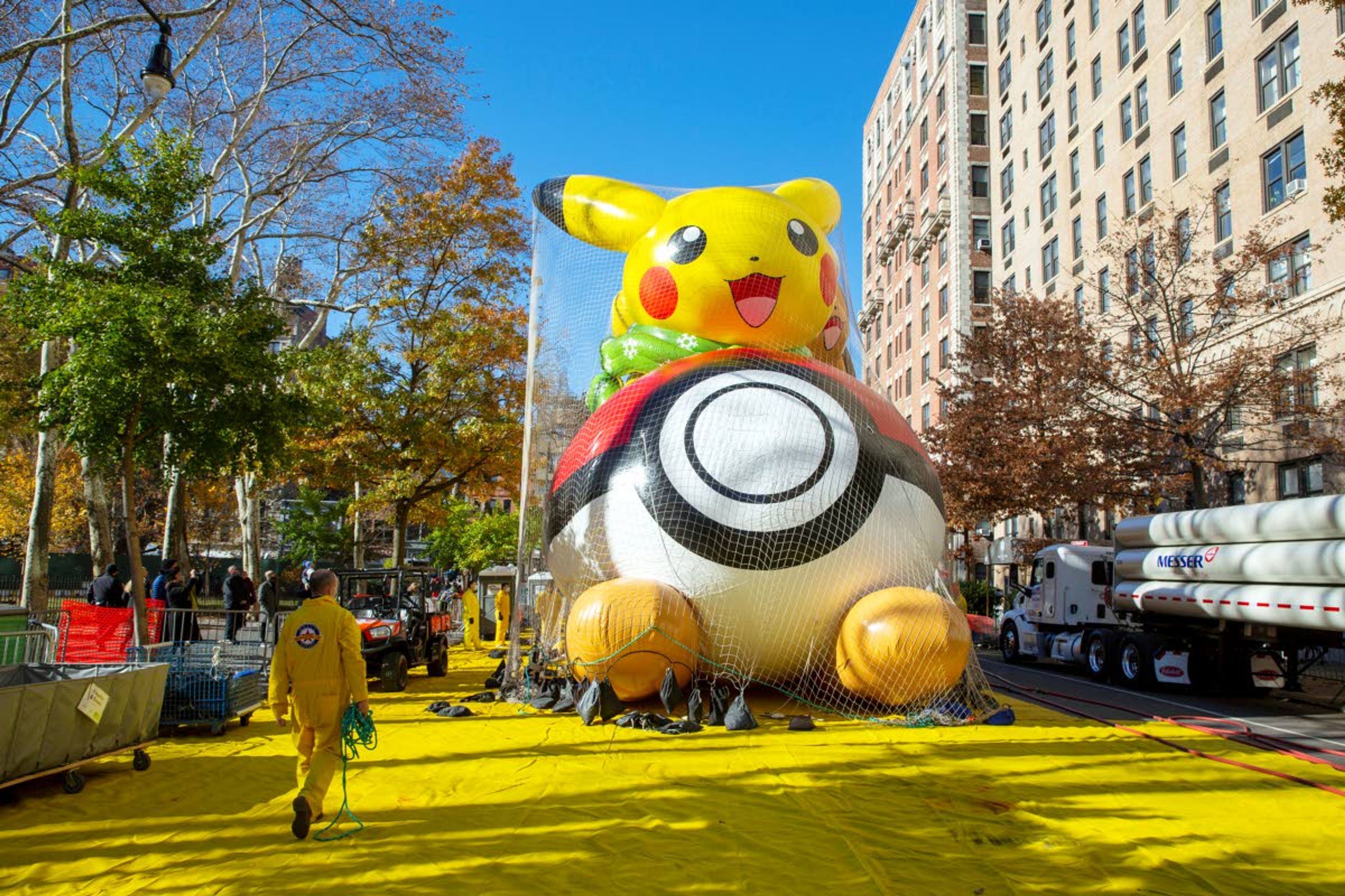 Crews pump helium into a balloon of Pikachu and Eevee in New York on Wednesday, Nov. 24, 2021, as the balloon is readied for the Macy's Thanksgiving Day Parade on Thursday. (AP Photo/Ted Shaffrey)