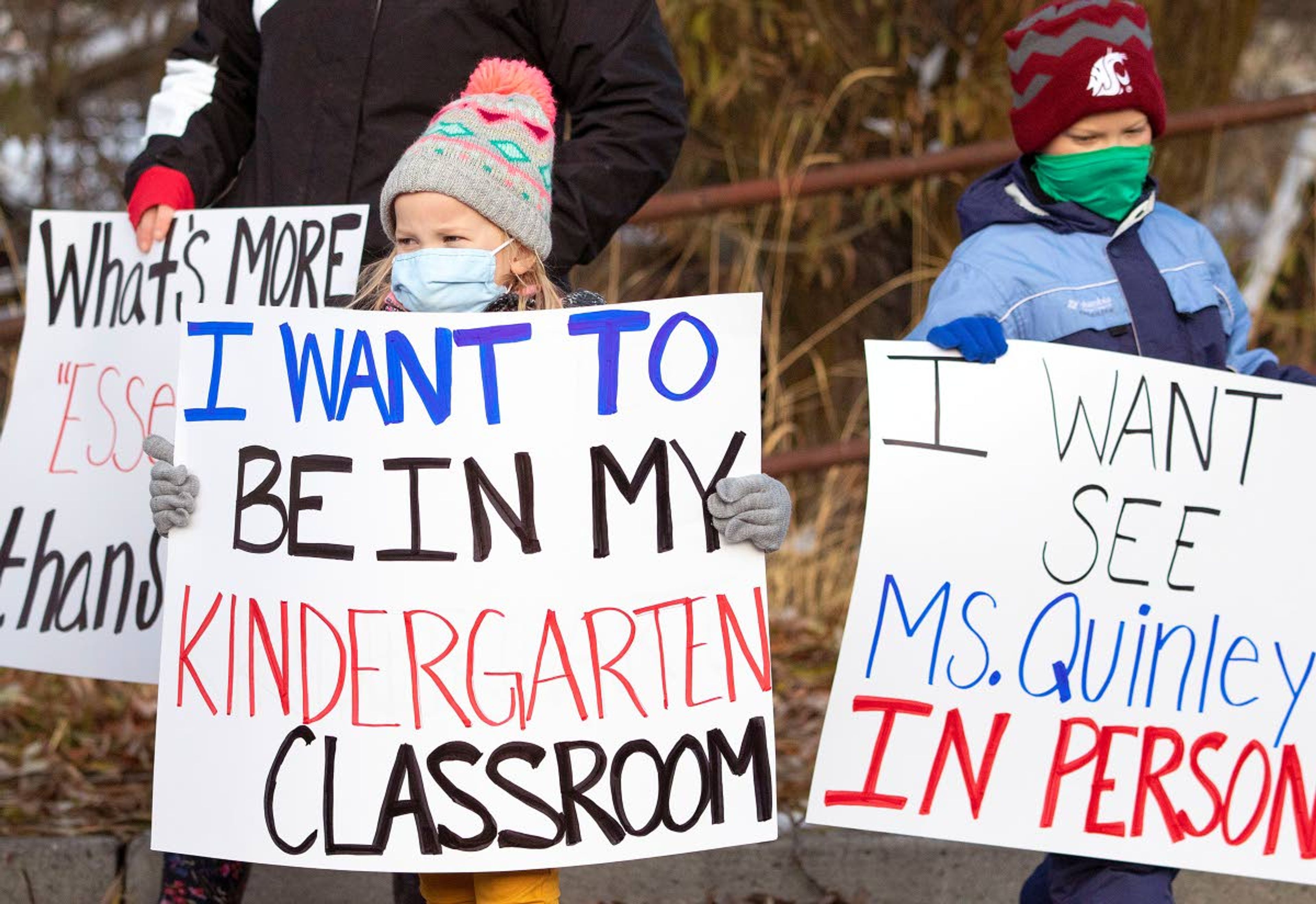 Kindergartener Shay Lovinger, left, and her older brother, Cody Lovinger, participate in a demonstration urging the school board to transition to in-person classes as soon as possible Monday in Pullman. More than 70 people participated in the event.