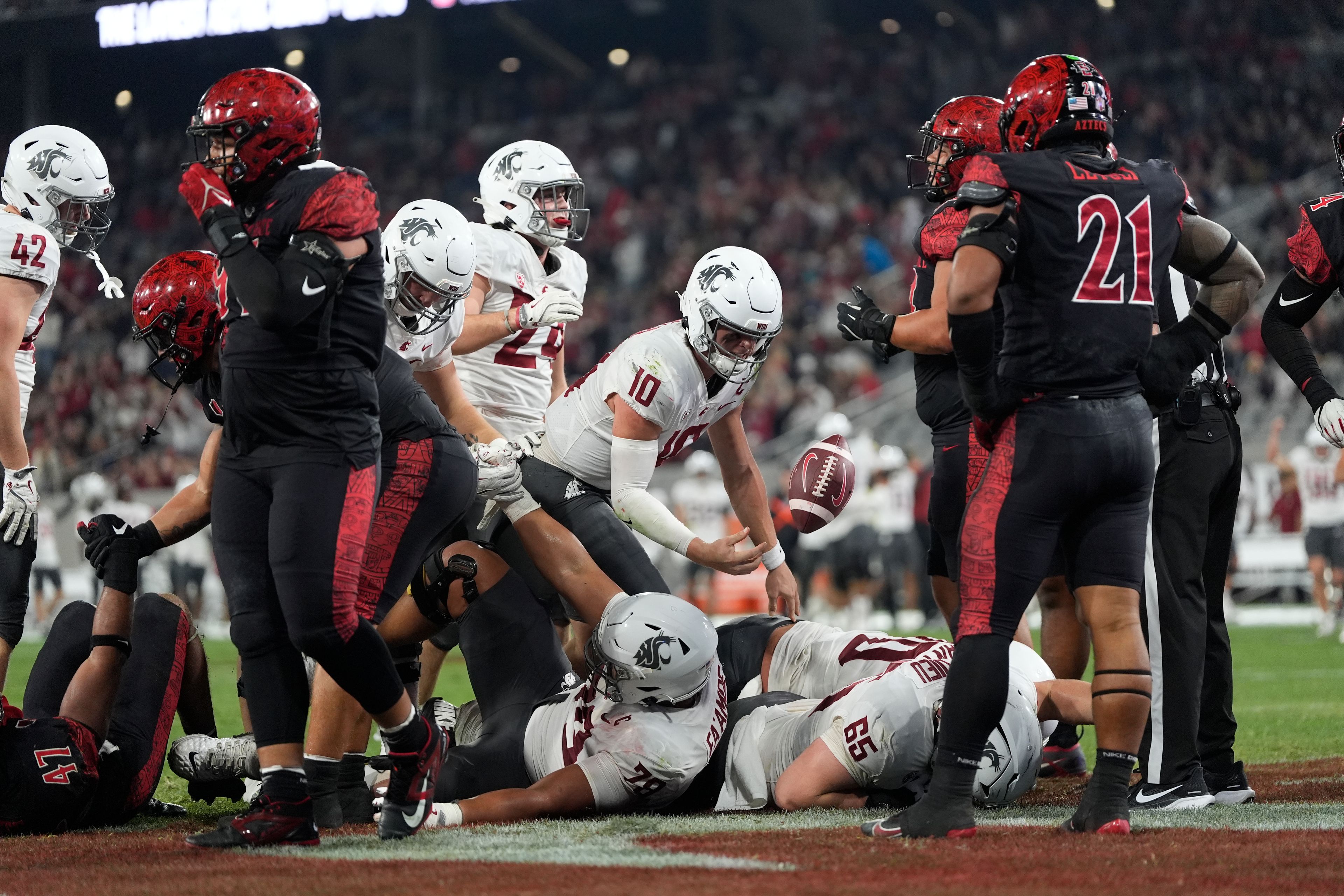 Washington State quarterback John Mateer, center, gets up after scoring a touchdown during the first half of an NCAA college football game against San Diego State Saturday, Oct. 26, 2024, in San Diego. (AP Photo/Gregory Bull)