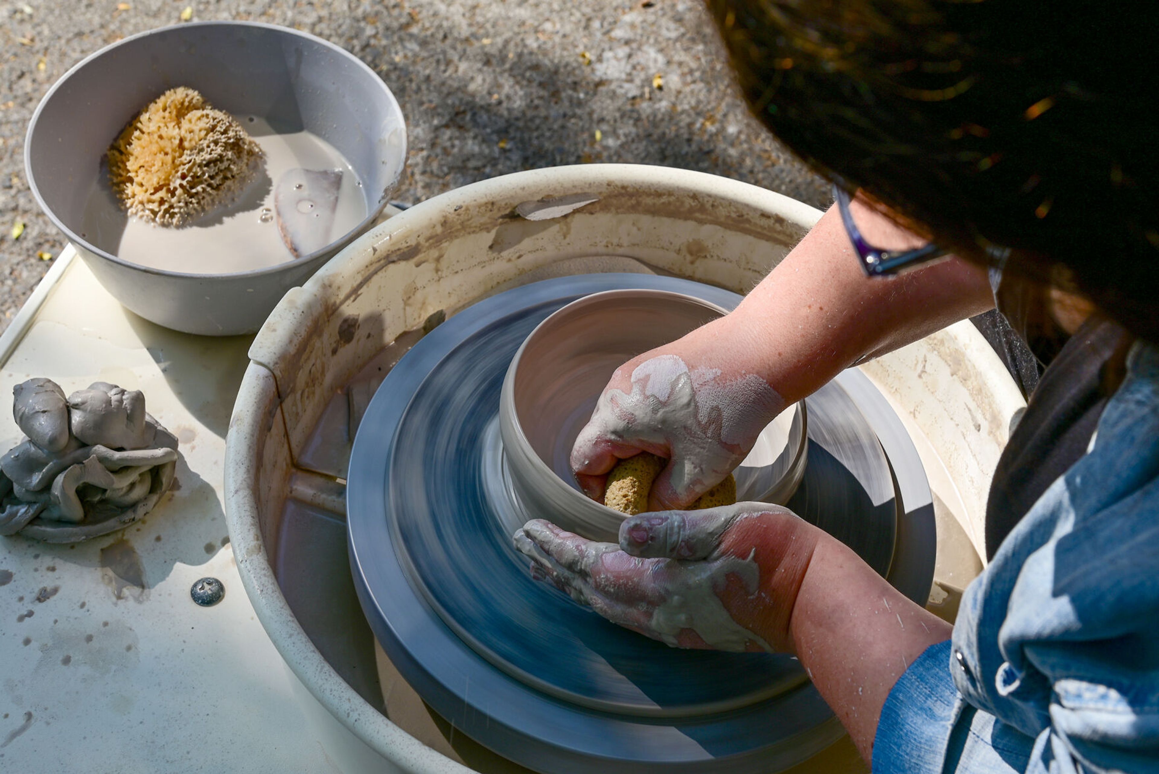 Owner and founder Candace Baltz creates forms wet clay on a potter's wheel on Wednesday outside of Terracotta’s new downtown Moscow space.