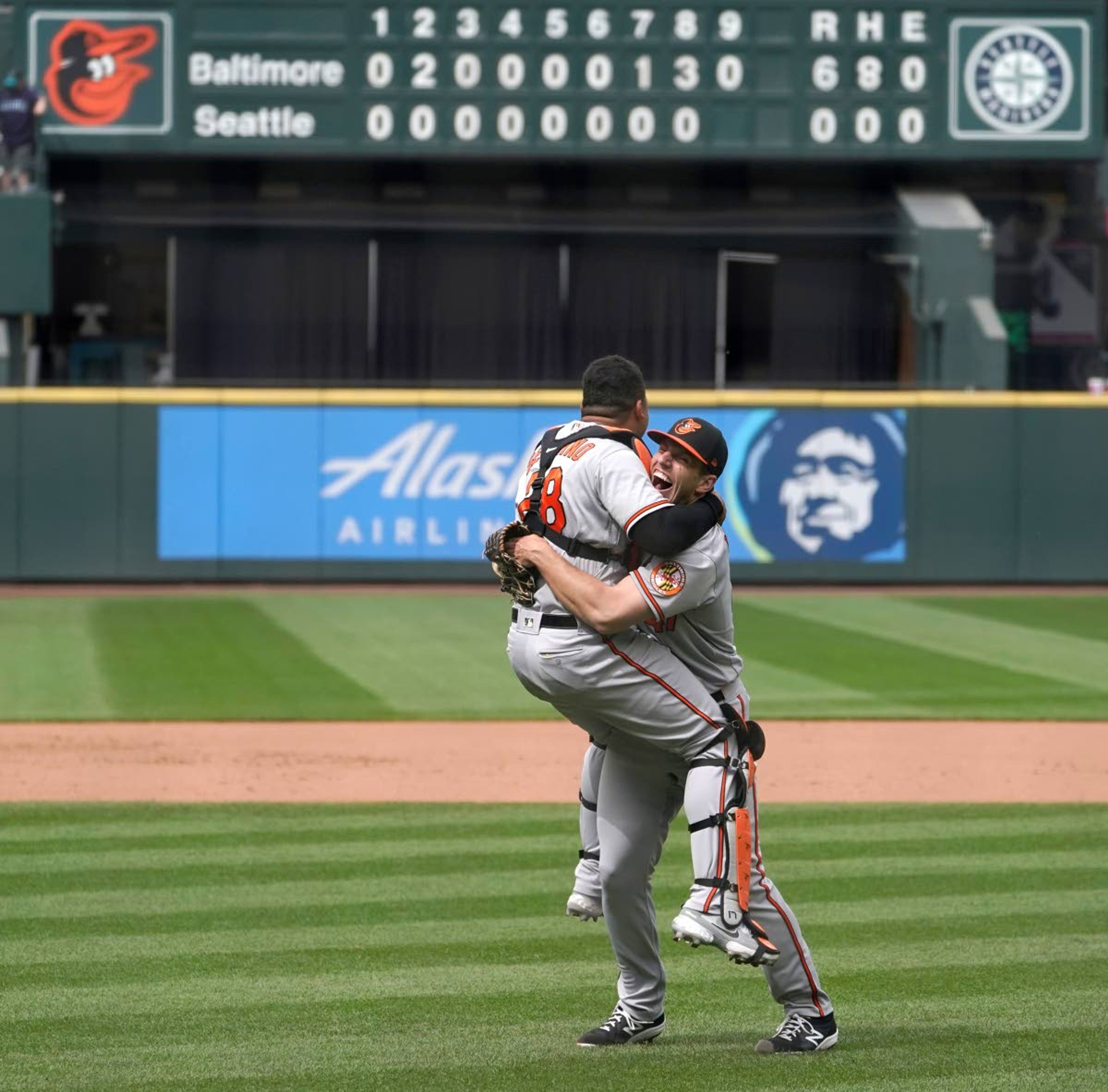 Baltimore Orioles starting pitcher John Means, right, hugs catcher Pedro Severino after Means threw a no-hitter baseball game against the Seattle Mariners, Wednesday, May 5, 2021, in Seattle. The Orioles won 6-0. (AP Photo/Ted S. Warren)