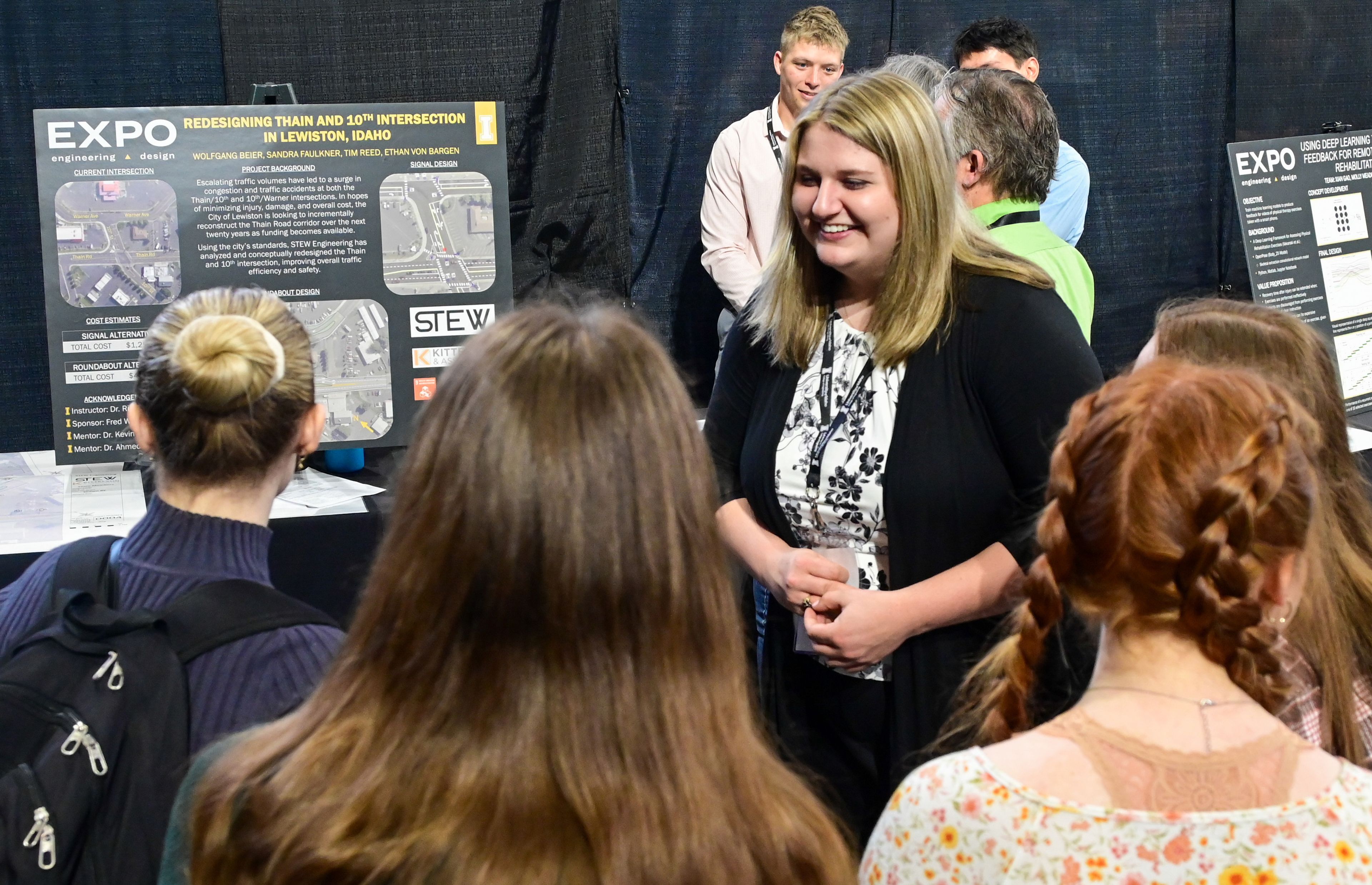 Sandra Faulkner, a senior civil engineering student at the University of Idaho, speaks with a group about a redesign project for the Lewiston intersection of Thain Road and 10th Street at the Engineering Design EXPO capstone presentations in Moscow on Friday.